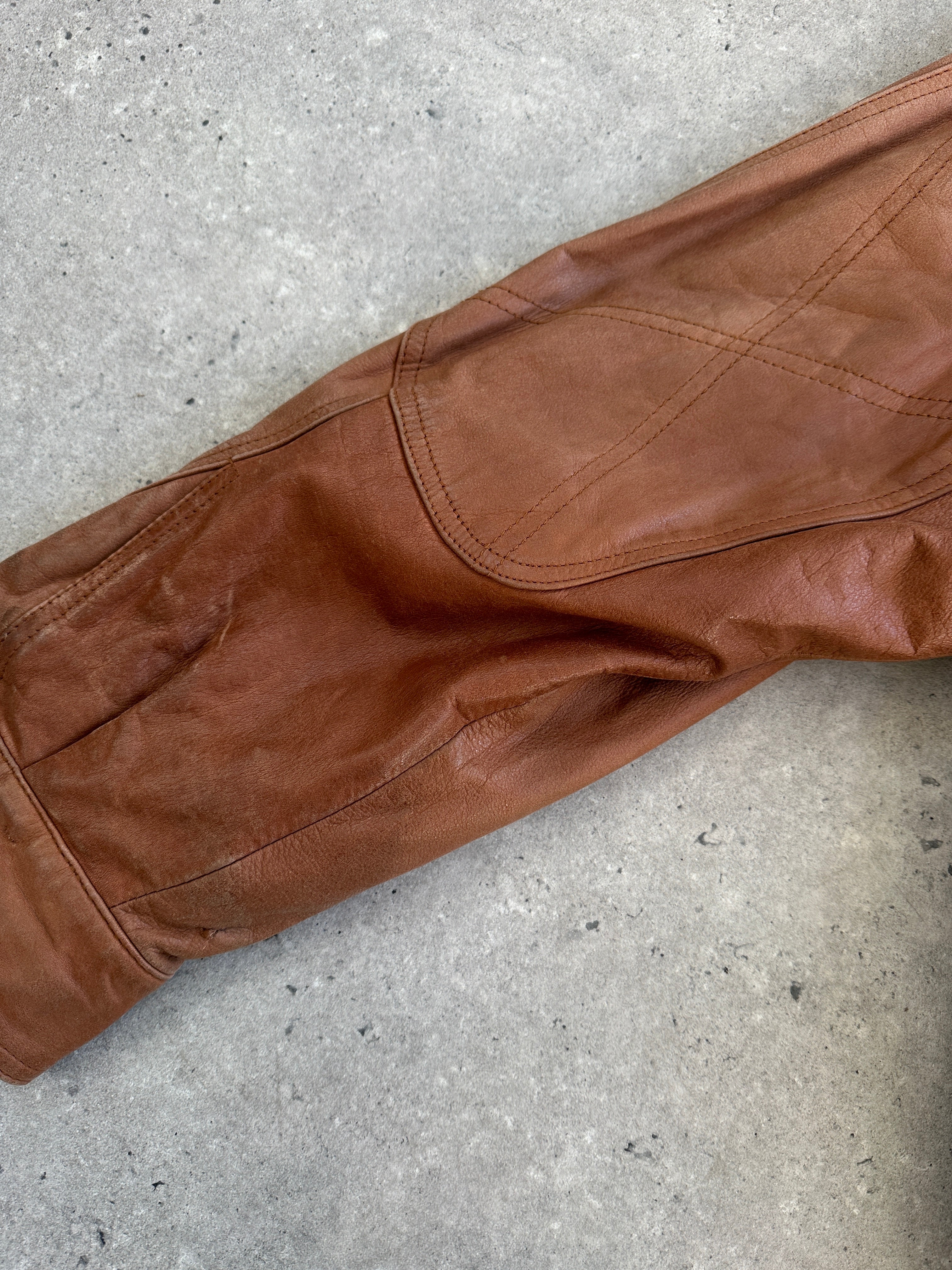 Vintage leather bomber jacket from the 1980s, in size large, featuring classic design and authentic leather material.