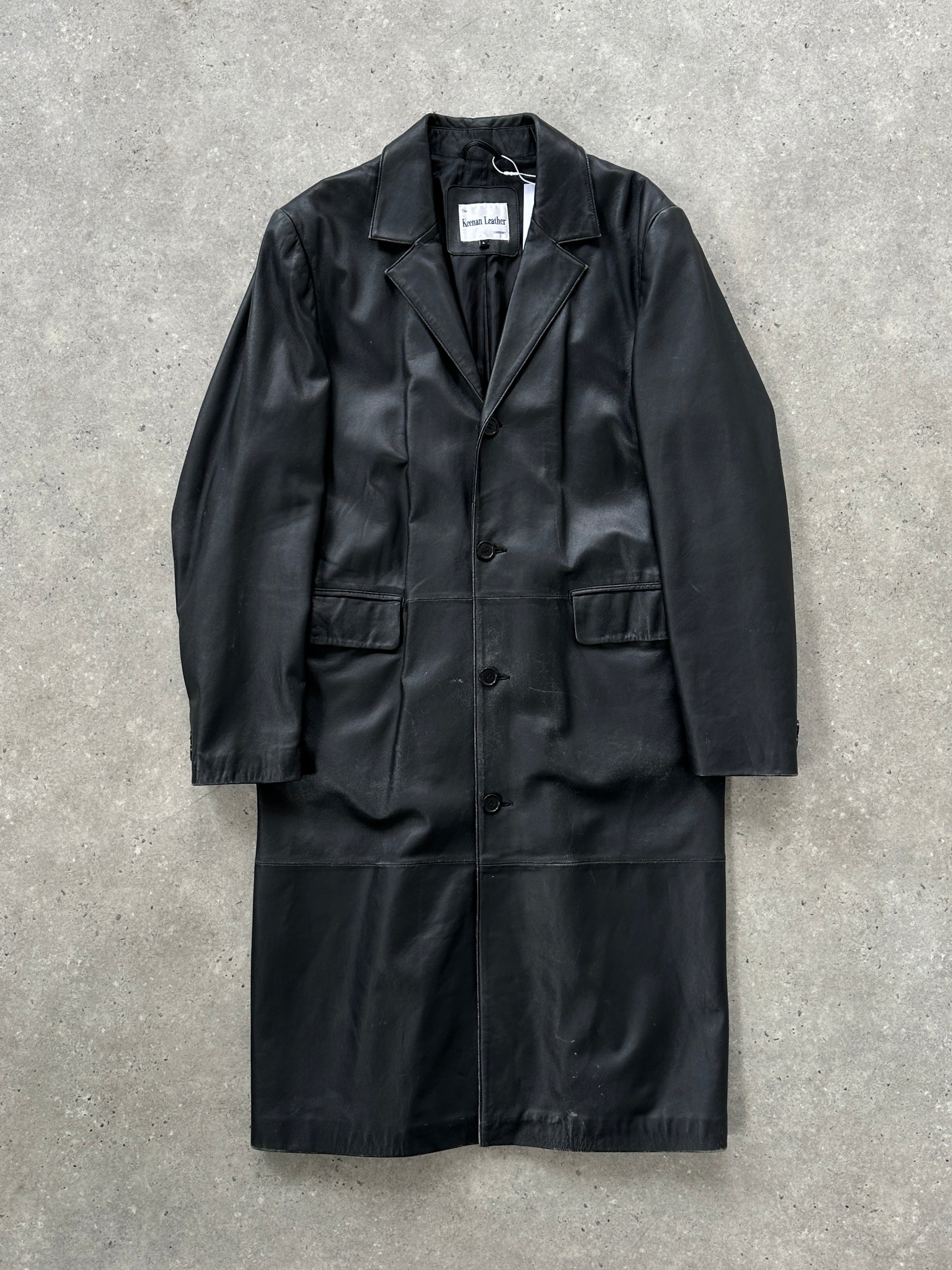 Vintage leather trench coat in XL, featuring classic design and rich leather texture, styled as a timeless leather jacket.