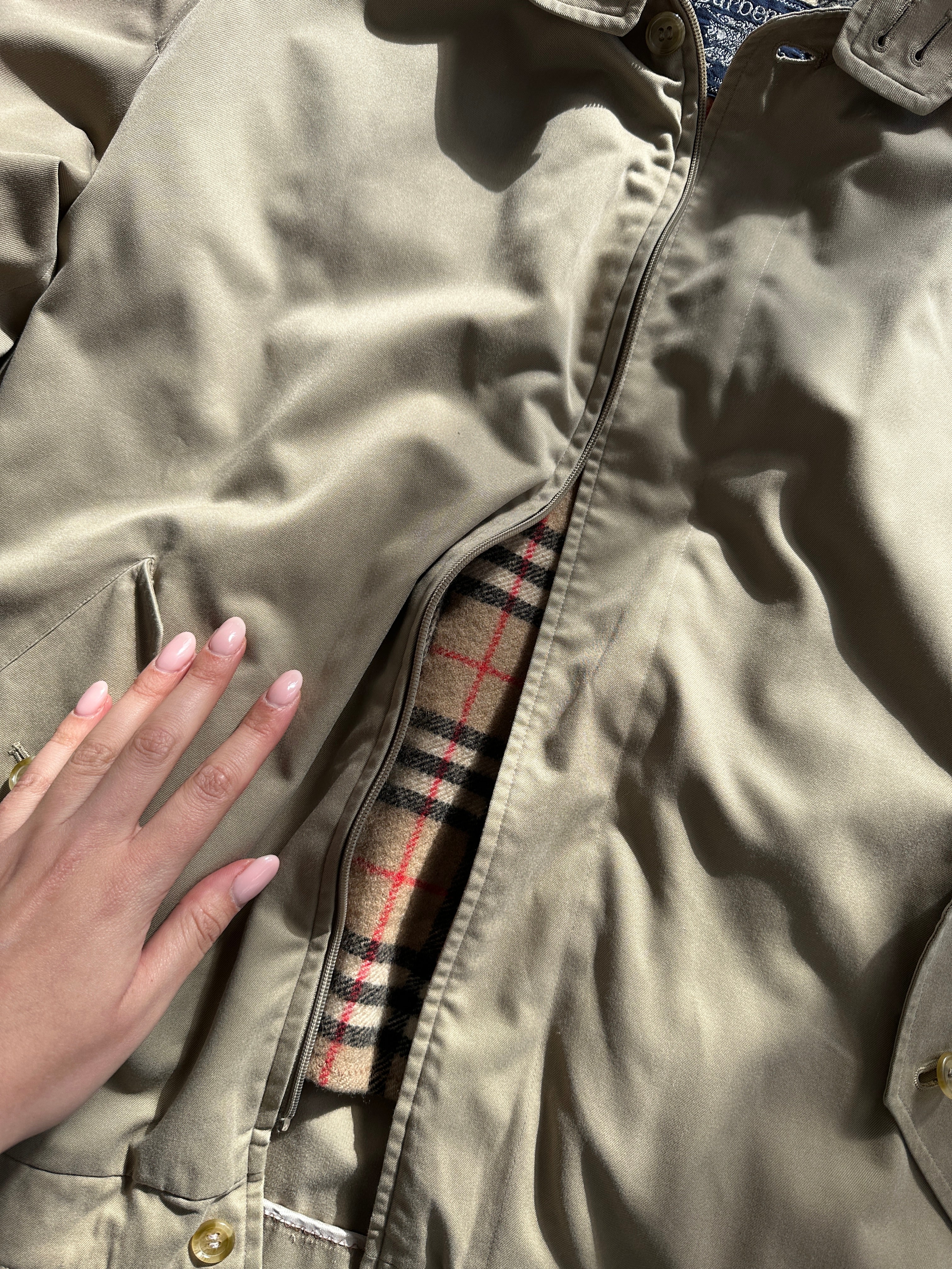 Burberry Nova Check bomber jacket in size large, featuring classic check pattern and casual fit, shown on a hanger.