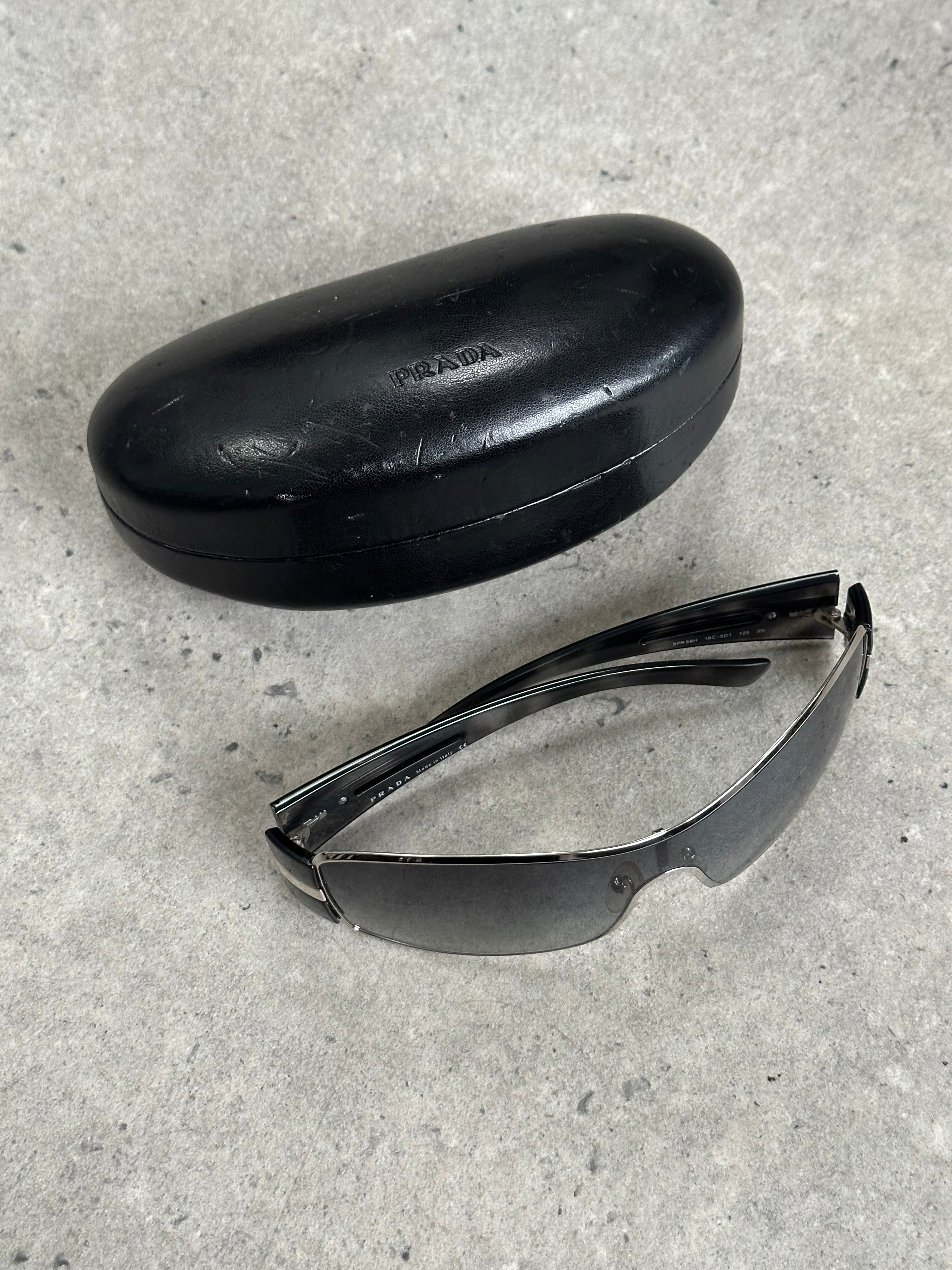 Prada 2000s aviator shield sunglasses with dark tinted lenses and metal frame, stylish and iconic eyewear.