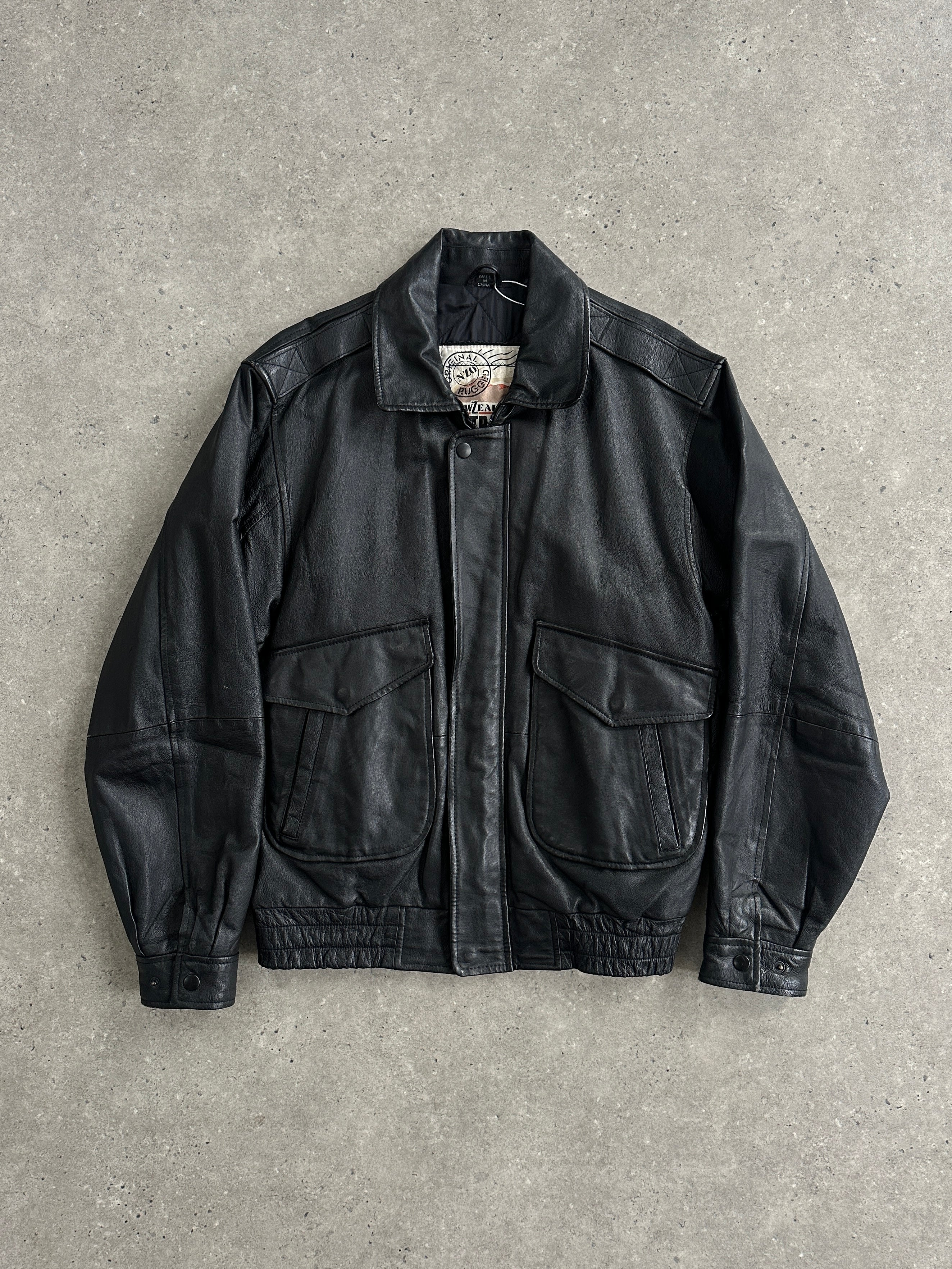 Vintage brand leather bomber jacket in size M/L, featuring a classic design with a worn-in leather texture and ribbed cuffs.
