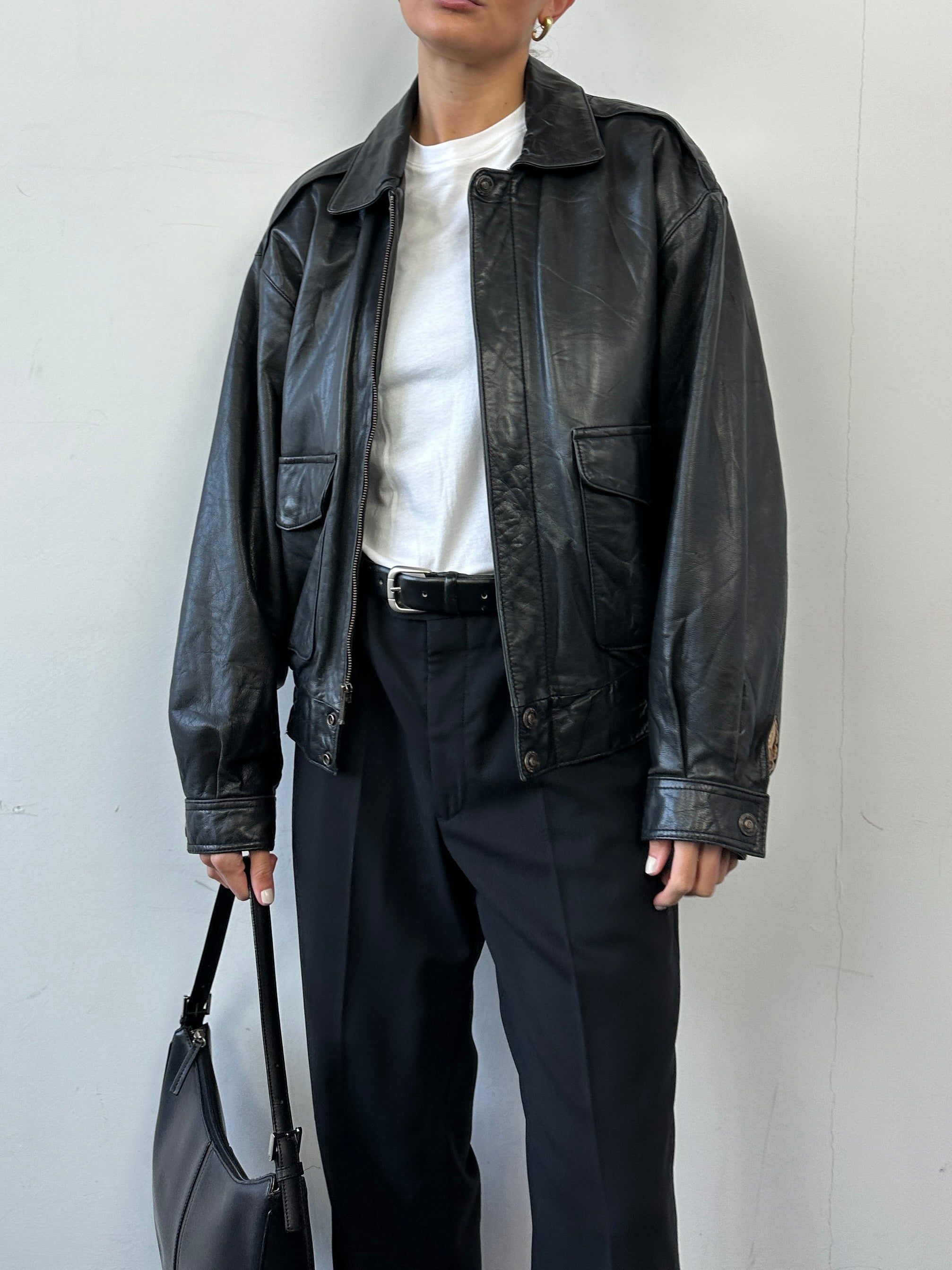 Vintage leather bomber jacket in size S/M, featuring classic design with durable leather and stylish detailing.