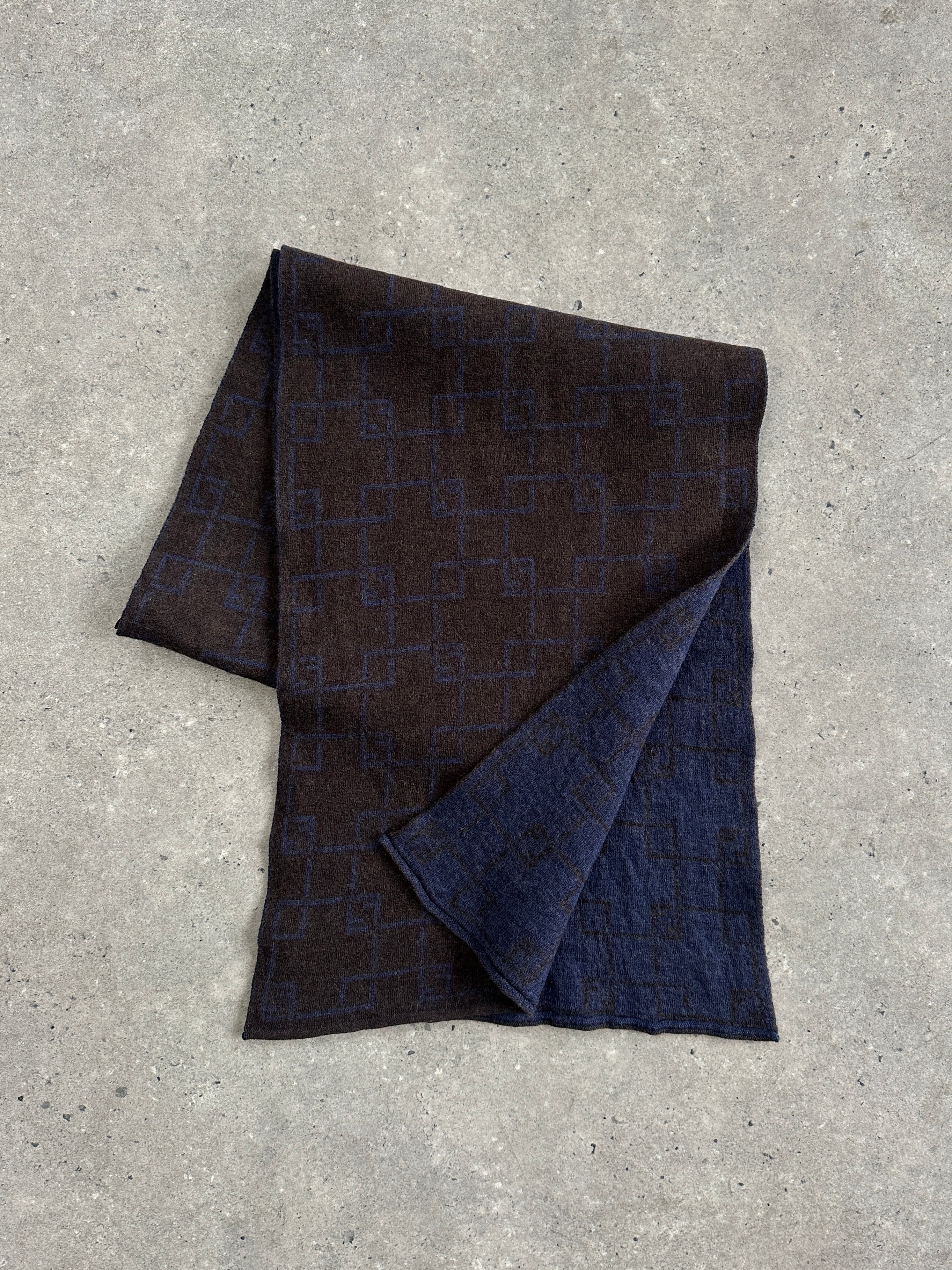 Fendi wool check scarf with classic plaid pattern, soft texture, and fringed edges, perfect for stylish cold-weather wear.