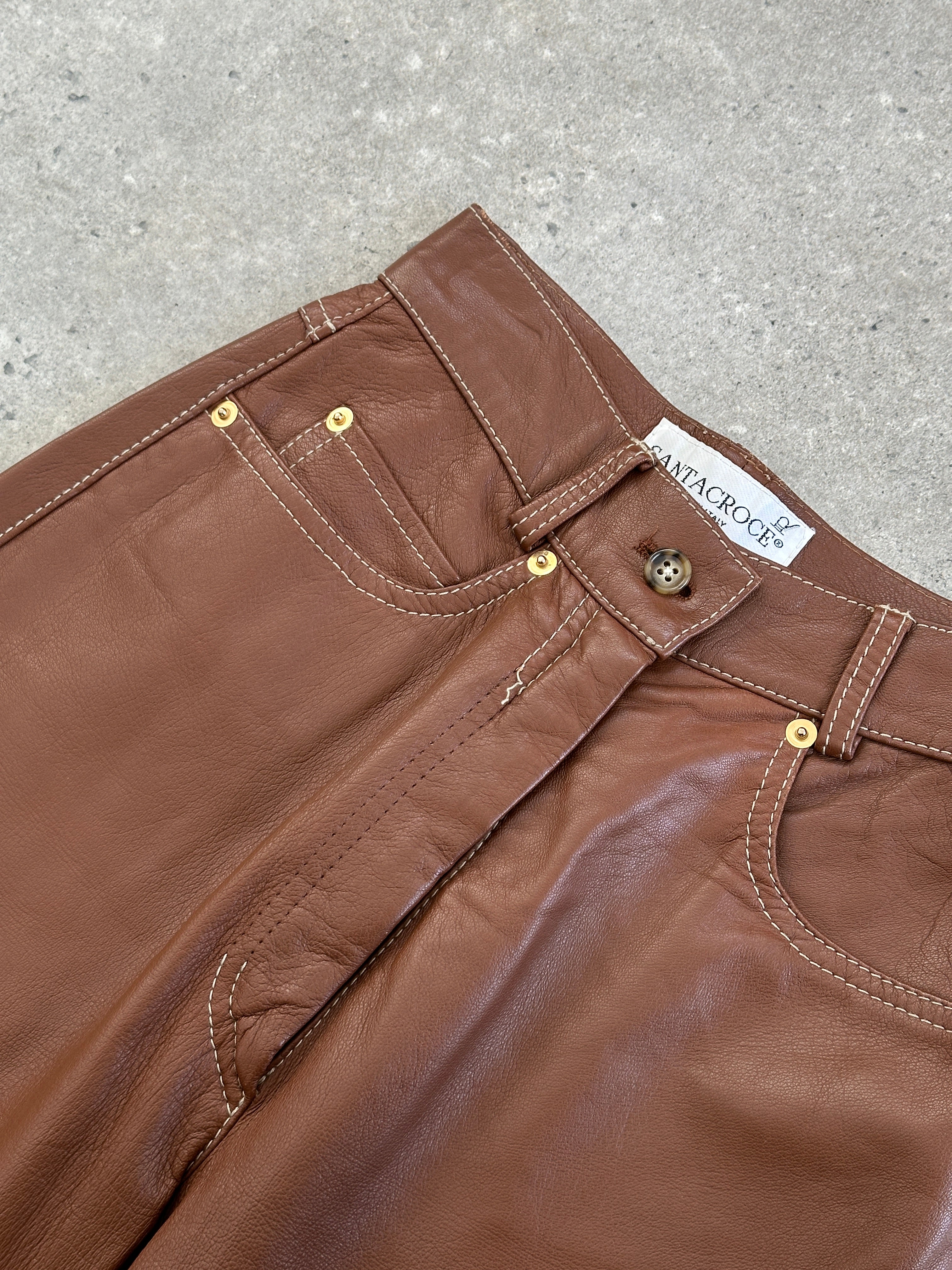 Vintage Italian high-waisted tapered leather trousers with a vintage style and sleek tapered leg design.