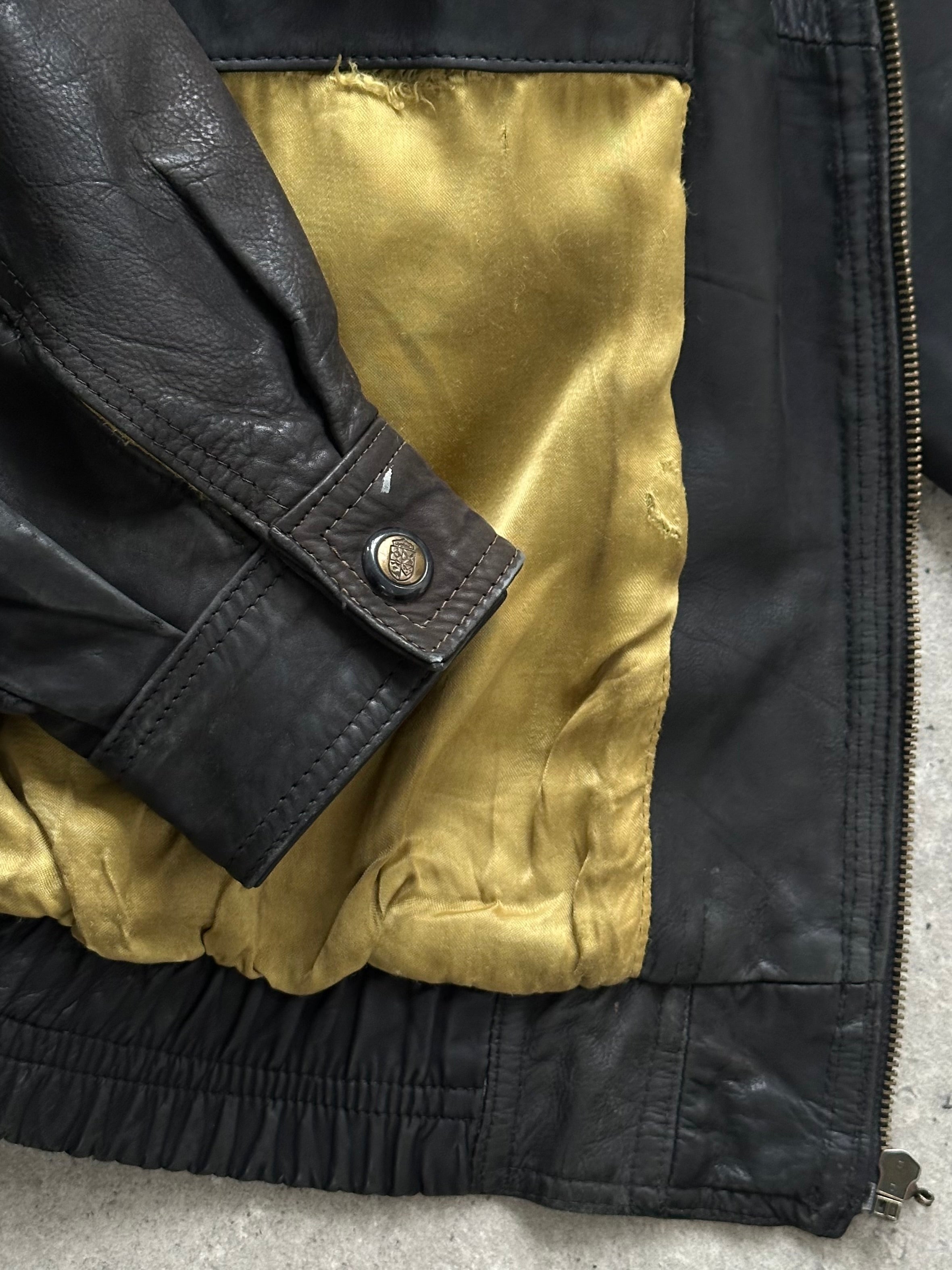 Vintage 1990s aged leather bomber jacket in XL size, featuring classic design and distressed leather details.