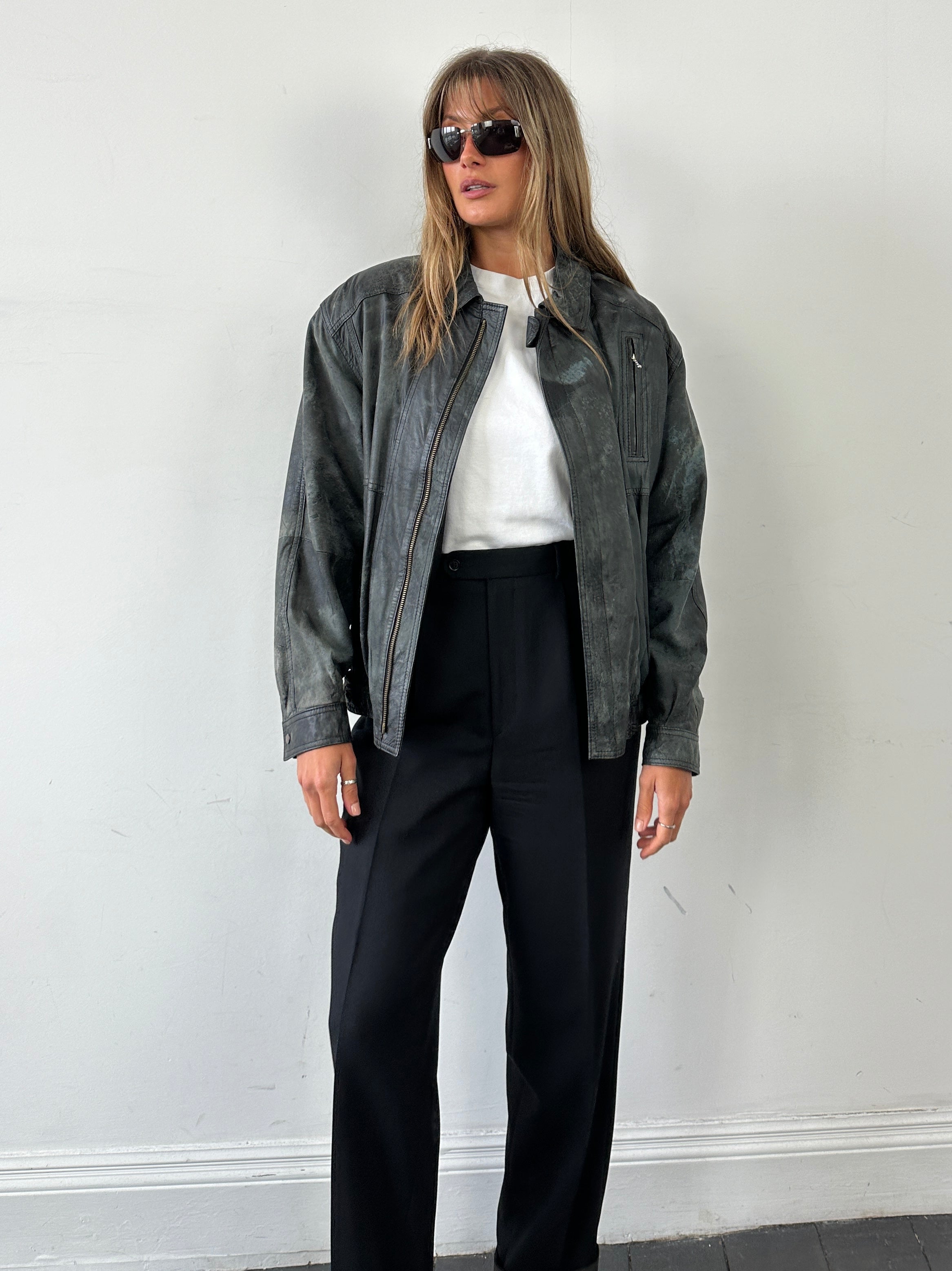 Vintage distressed marbled leather jacket in size M, showcasing rugged texture and stylish design.