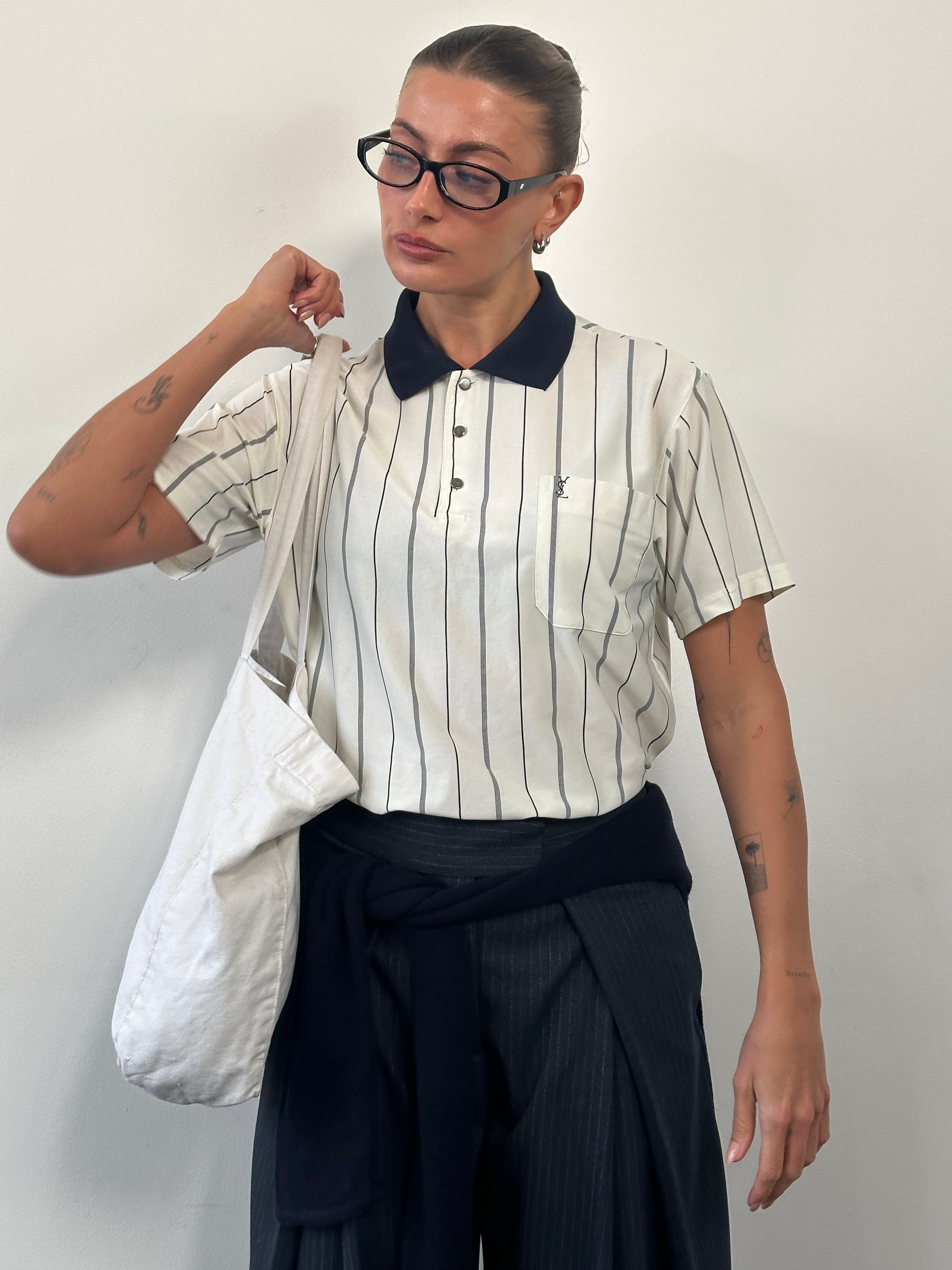Yves Saint Laurent 1990s pure silk stripe polo shirt in size M, displayed on a hanger showing its classic design and vibrant colors.