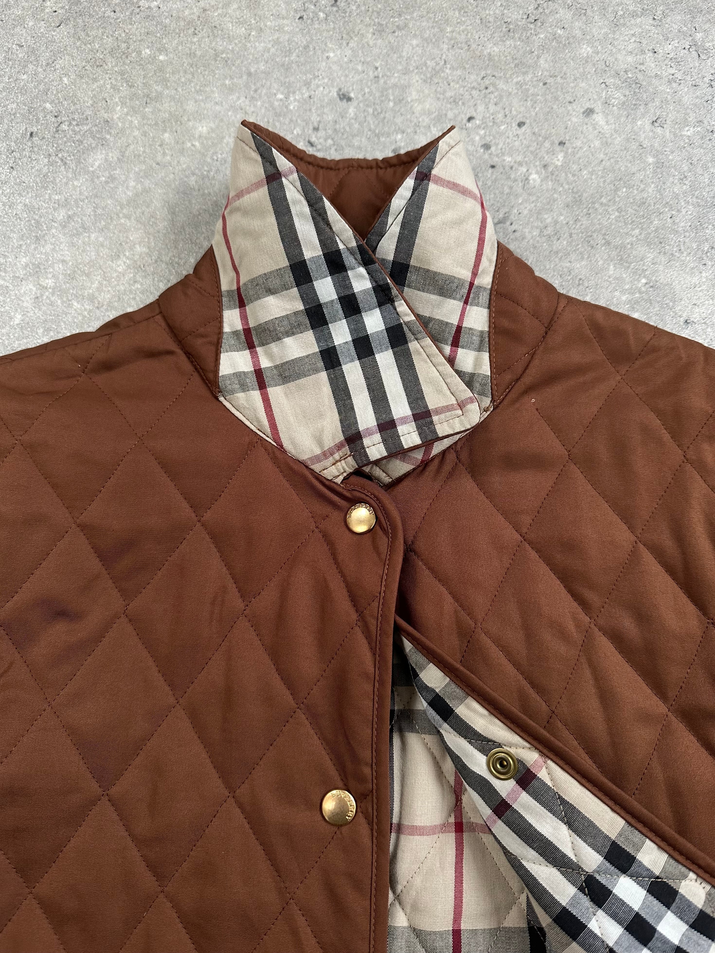 Burberry 2000s quilted Nova Check jacket in size M with classic check pattern and padded design, displayed on a hanger.