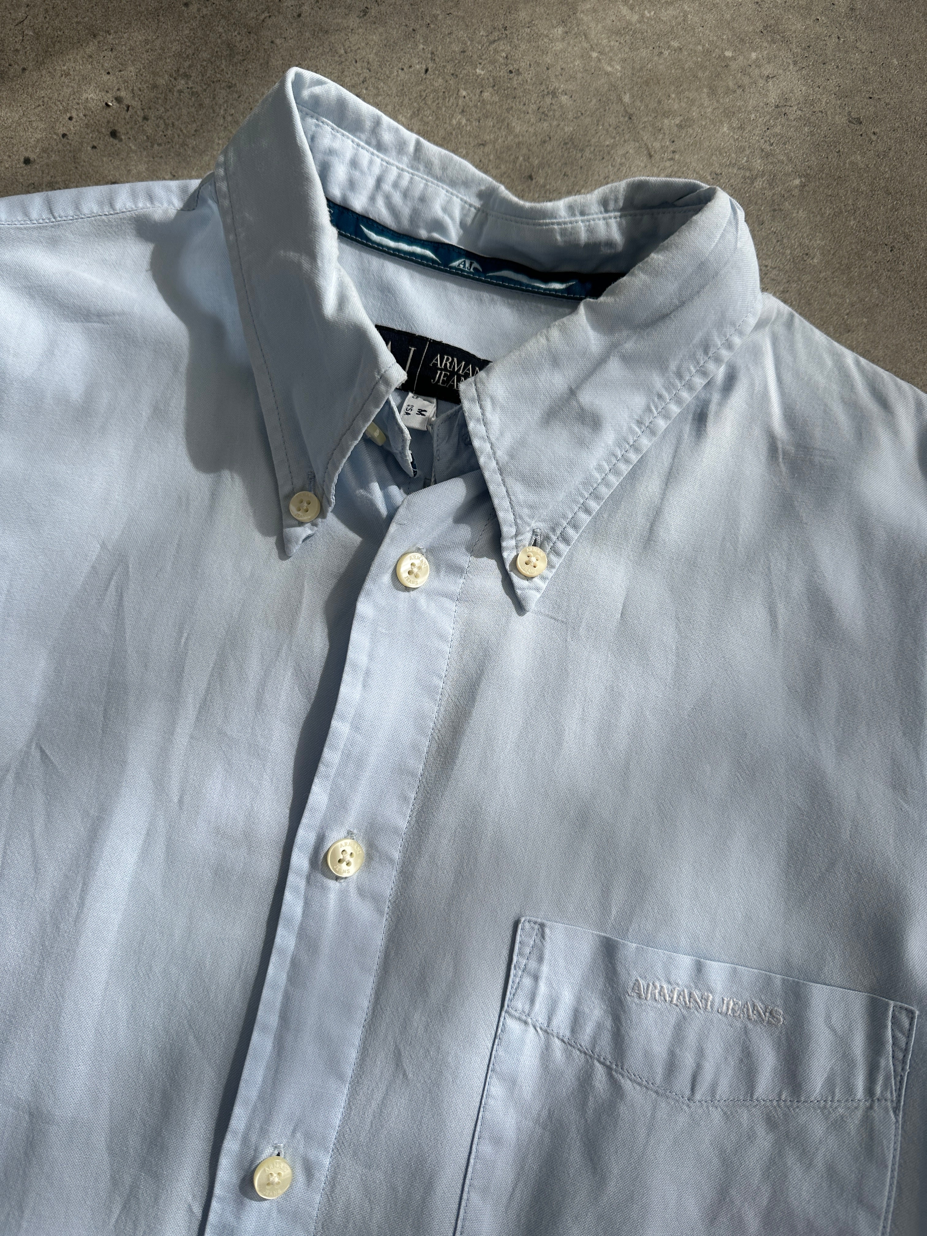 Armani Jeans pure cotton logo shirt in size large, featuring a classic design with the Armani logo visible on the front.