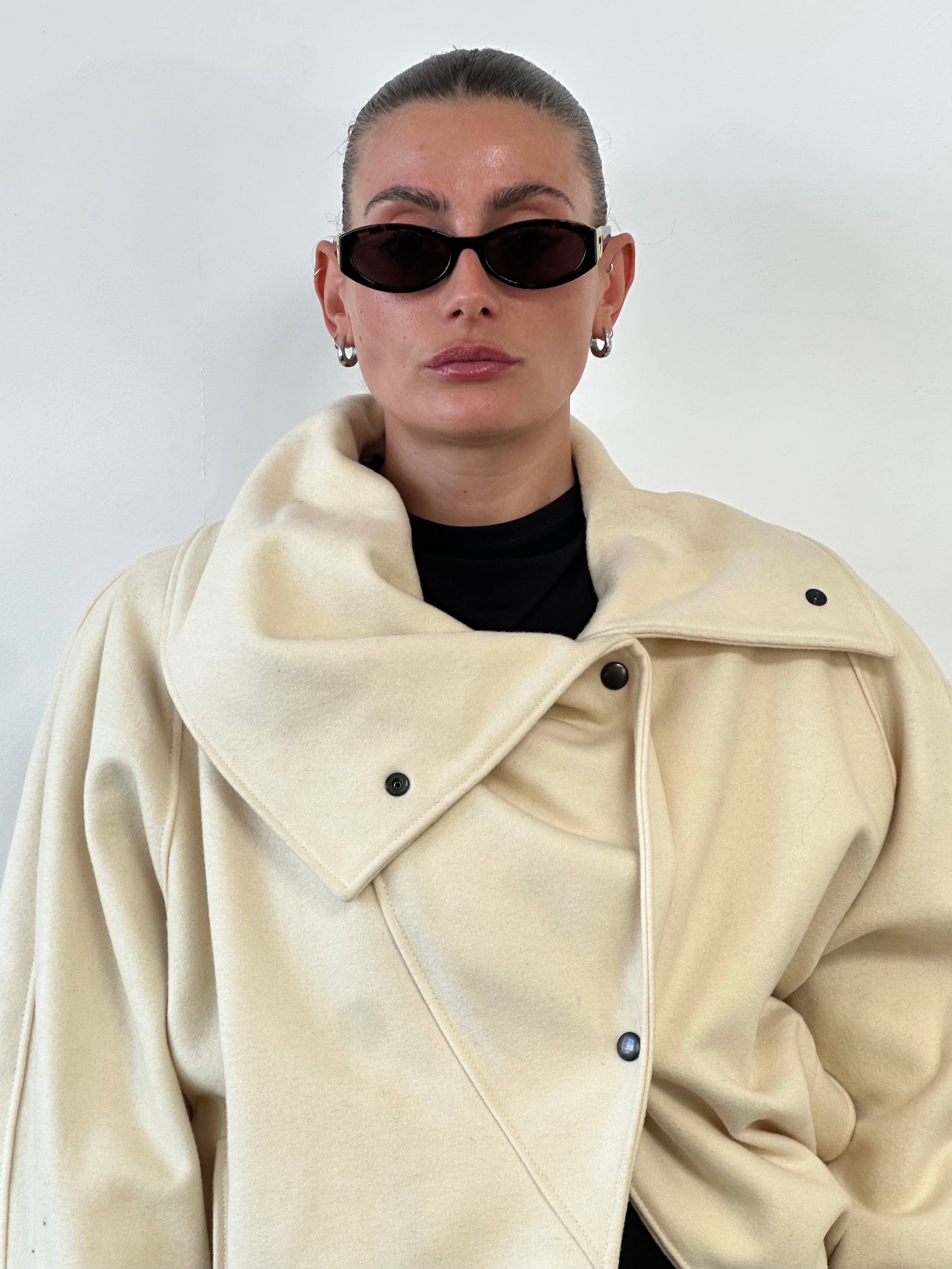 Vintage asymmetric wool bomber jacket with funnel neck in classic style, shown in black with silver zipper details.