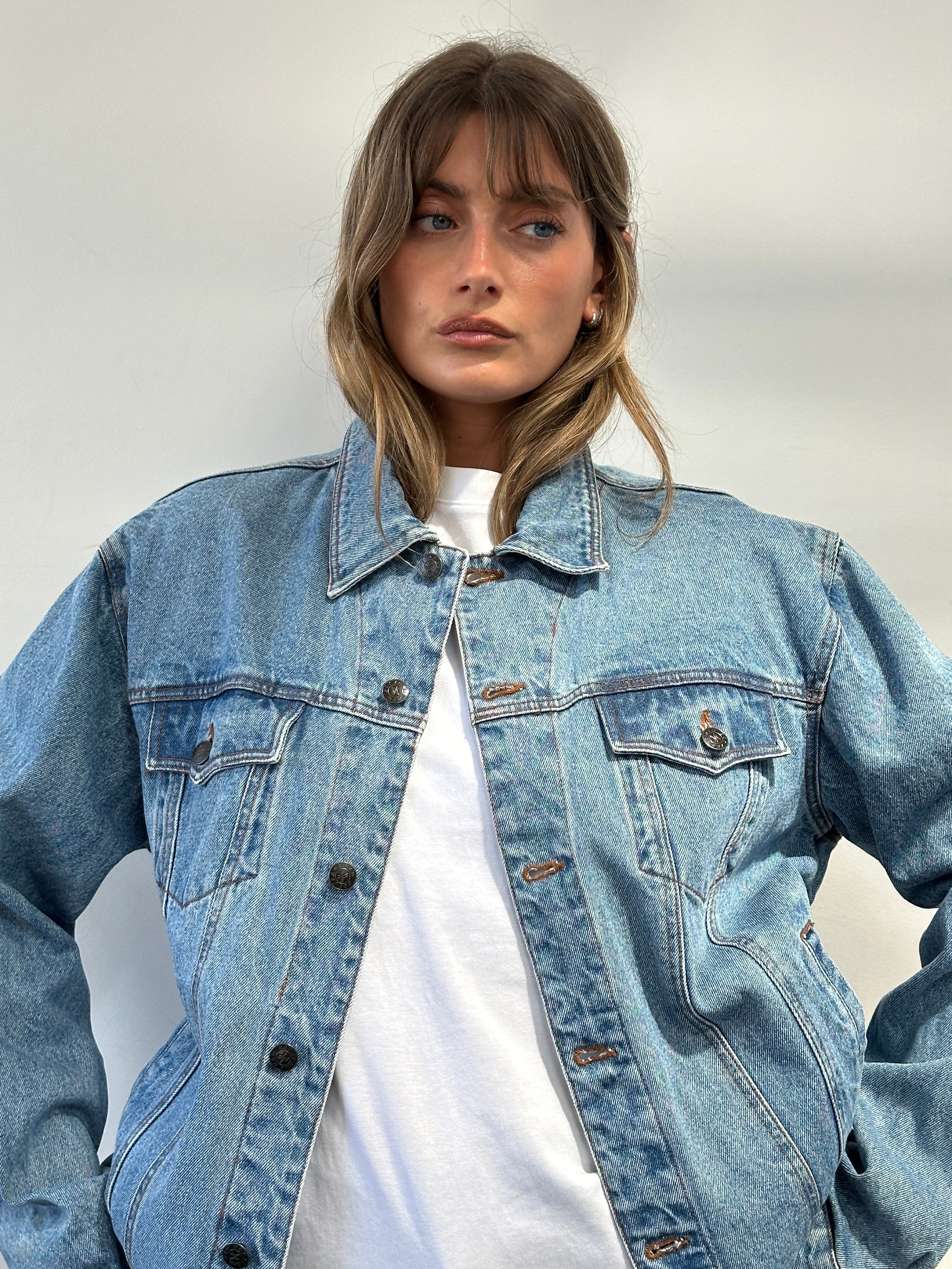 Vintage oversized pure cotton denim jacket with classic design, shown in a natural stance, available in M/L size.