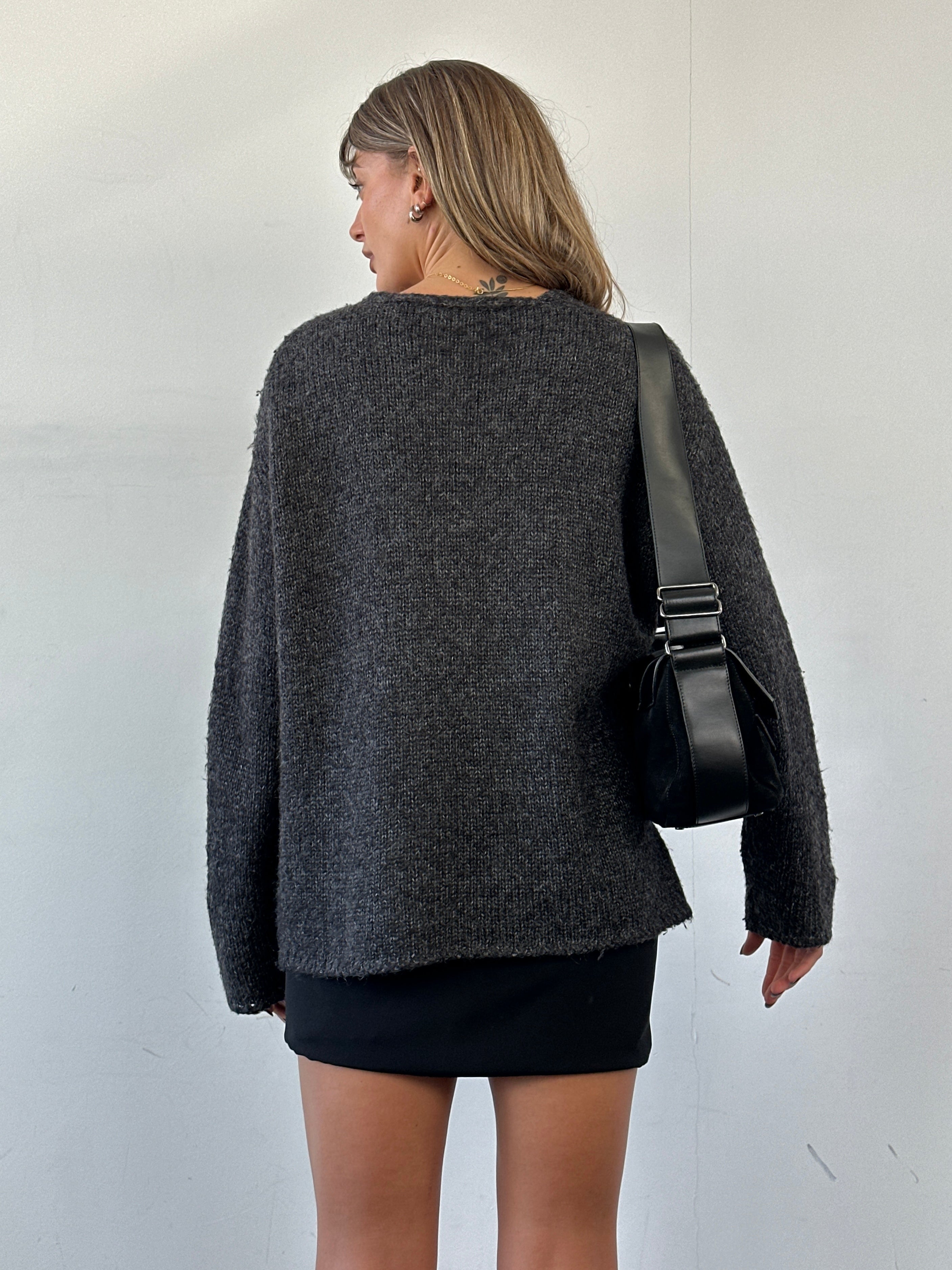 Max Mara XL mohair V-neck knitted jumper displayed on a hanger, showcasing its soft texture and classic design.