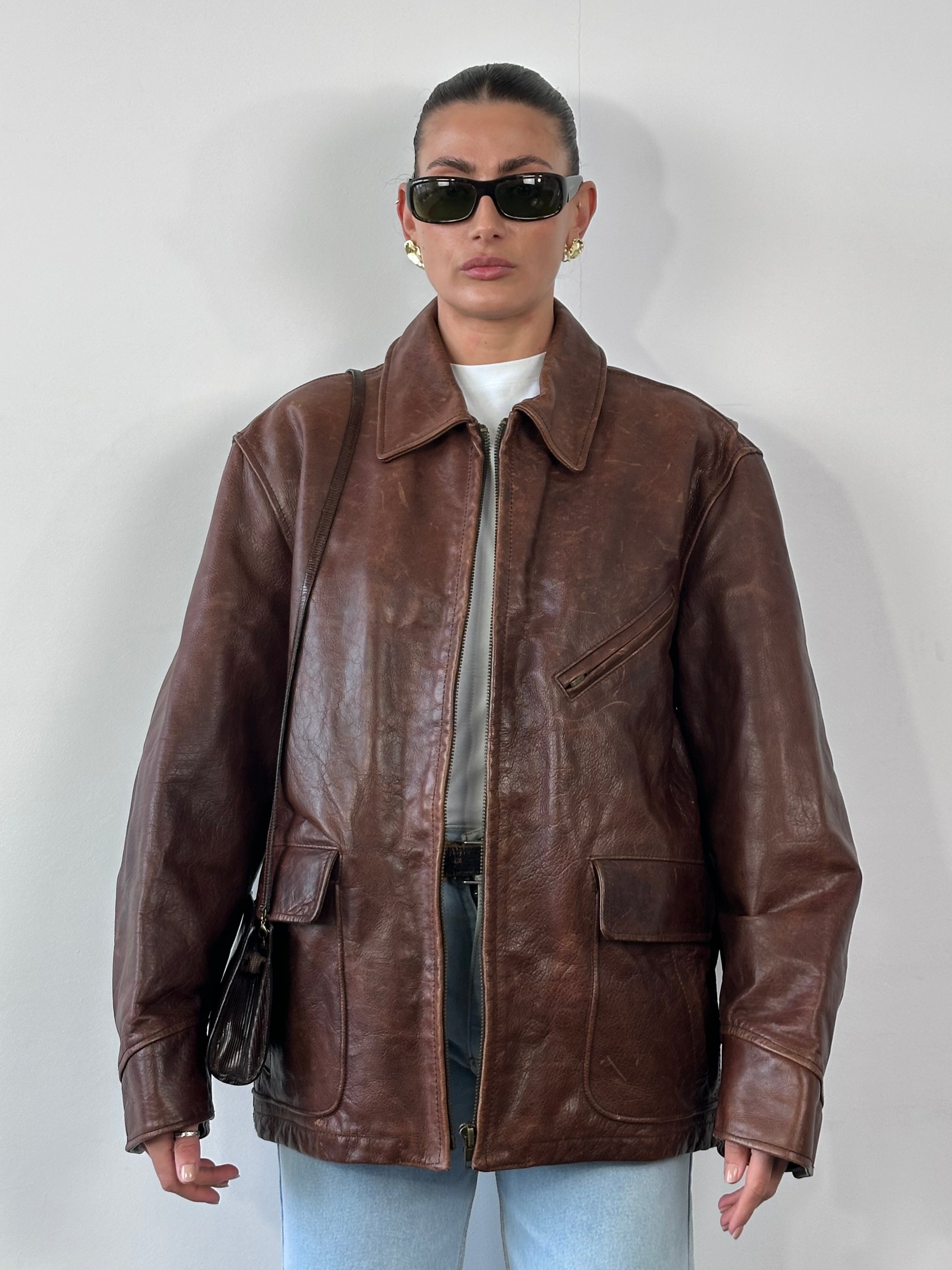 Vintage heavyweight leather jacket in size XL with a rugged aged appearance, featuring classic collar and front button closure.