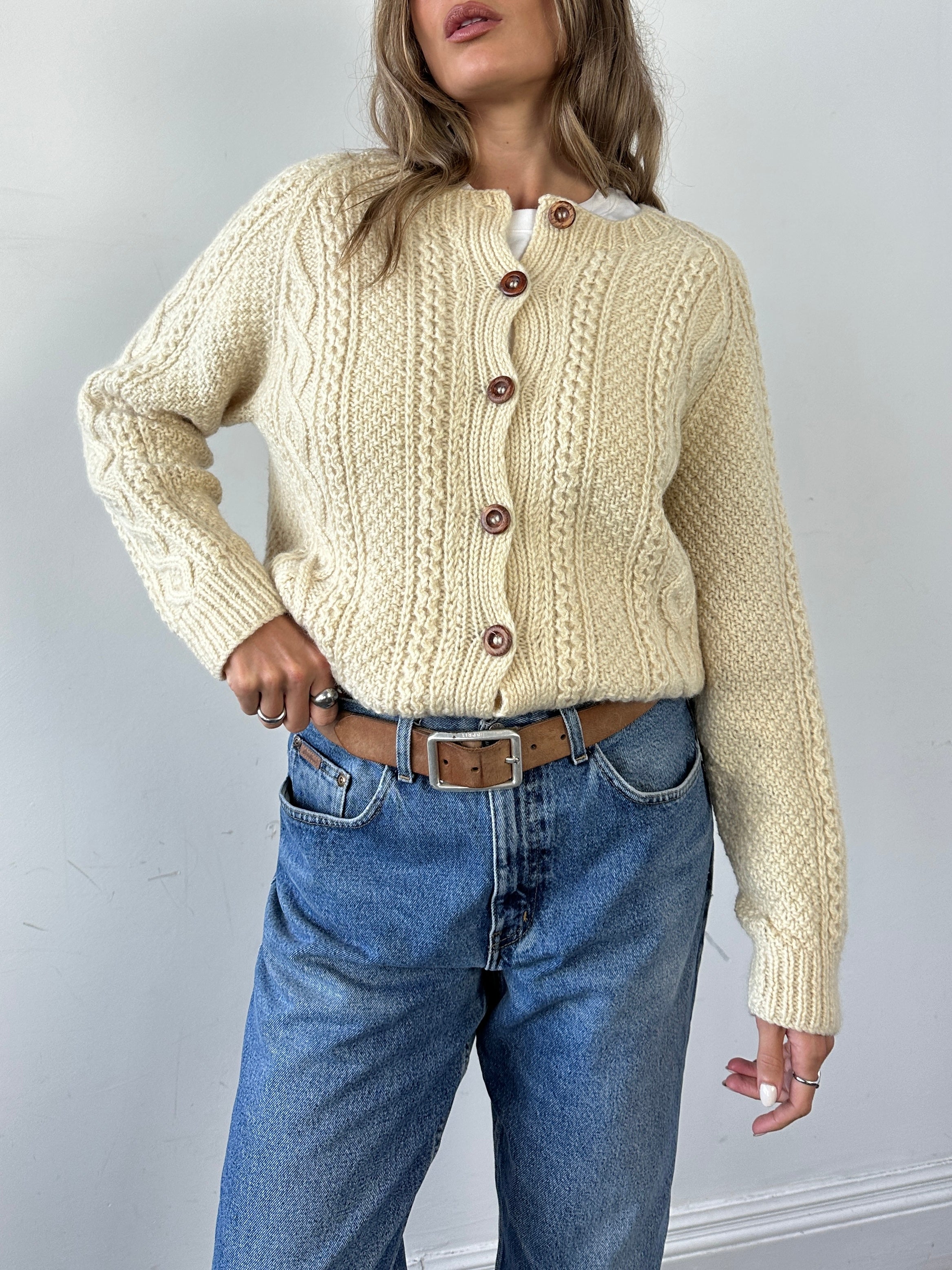 Vintage wool cable knit cardigan in size large, featuring textured pattern and classic design, perfect for cozy, stylish layering.