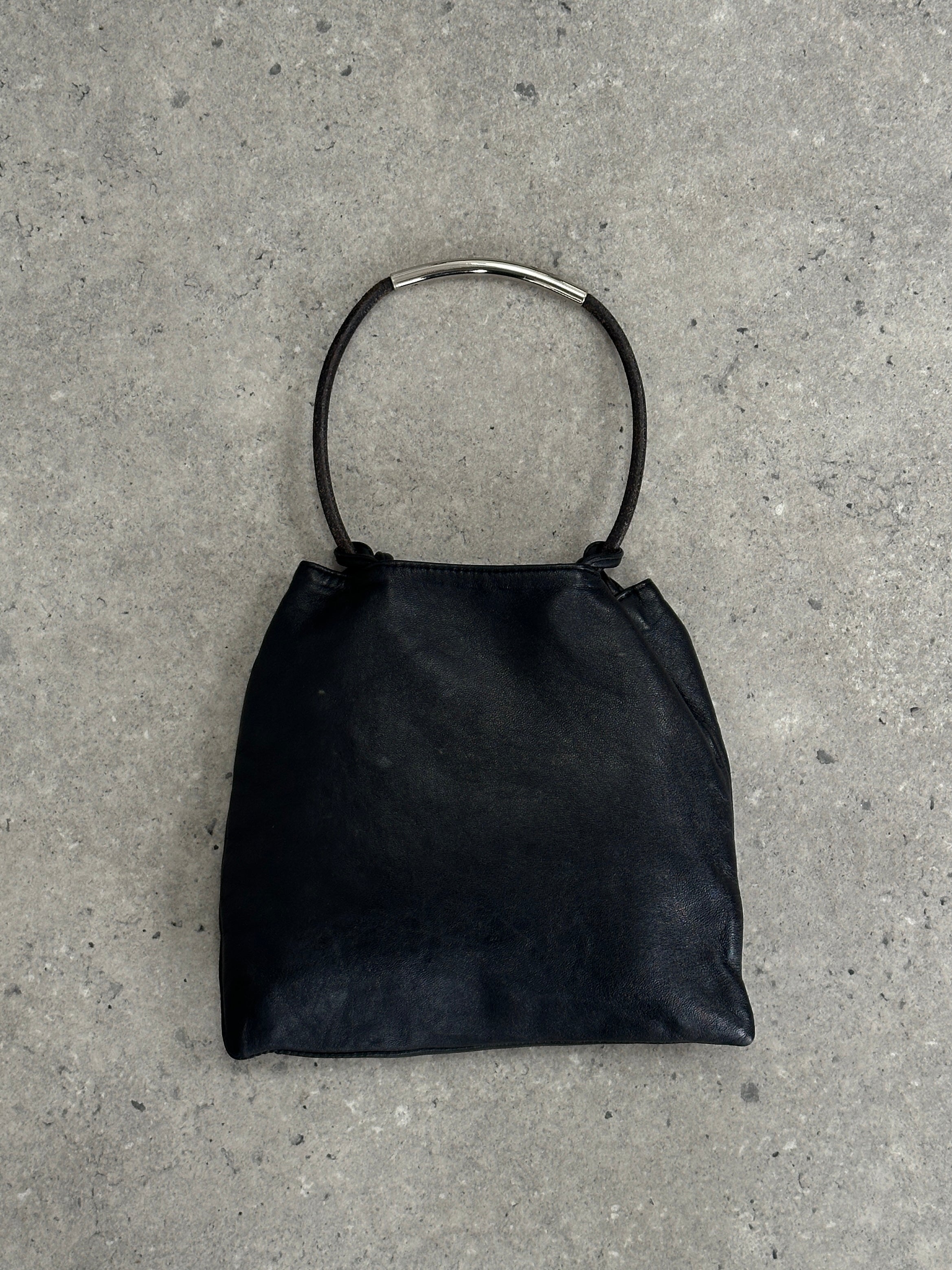 DKNY soft leather clutch bag with sleek design and compact size, perfect for stylish evening or daytime use.