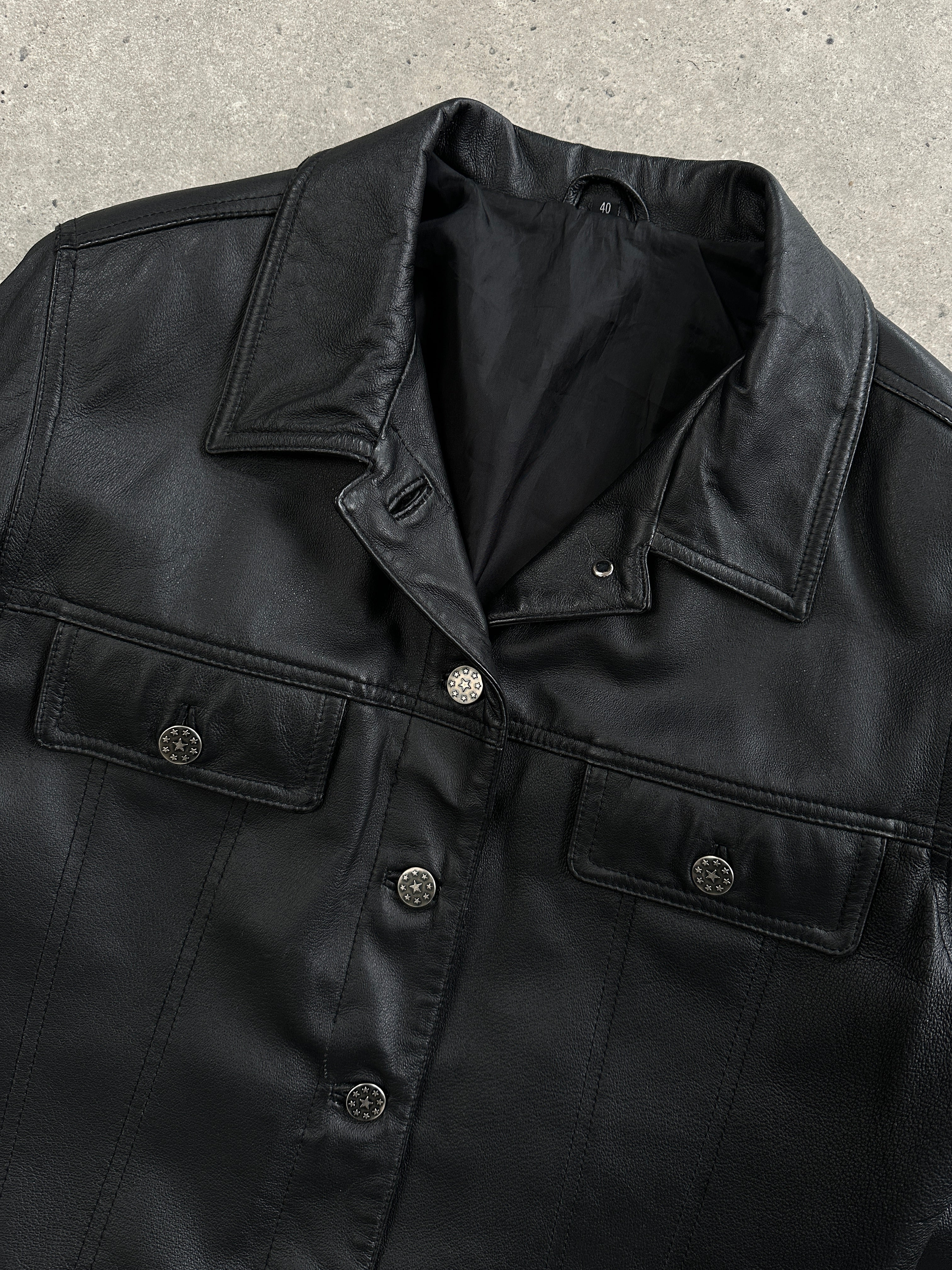 Vintage boxy leather jacket in black, featuring classic design and textured leather, displayed on a neutral background.