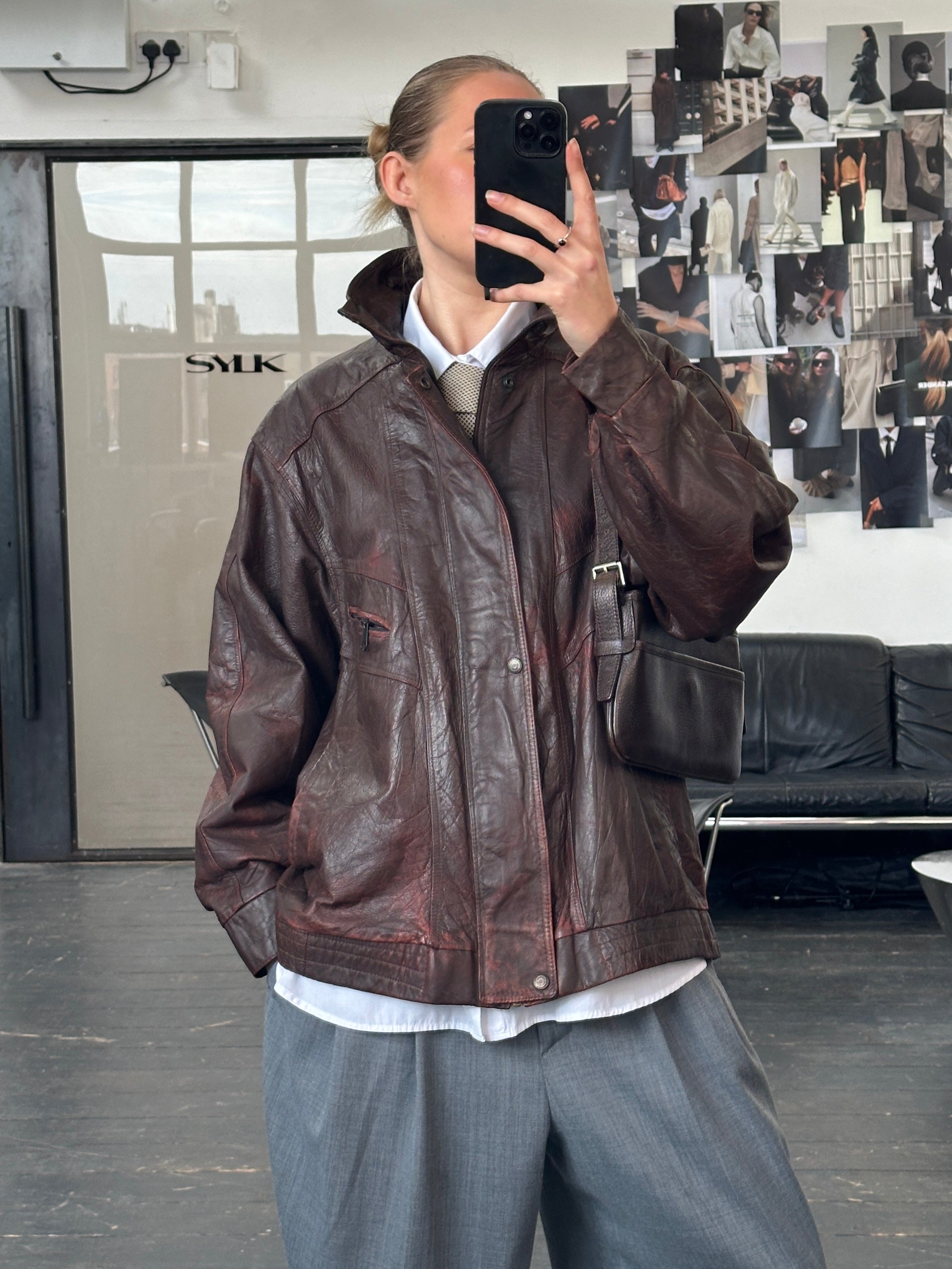 Vintage 1990s leather bomber jacket with funnel neck, aged leather, in size XL, featuring a classic vintage style and detailed stitching.