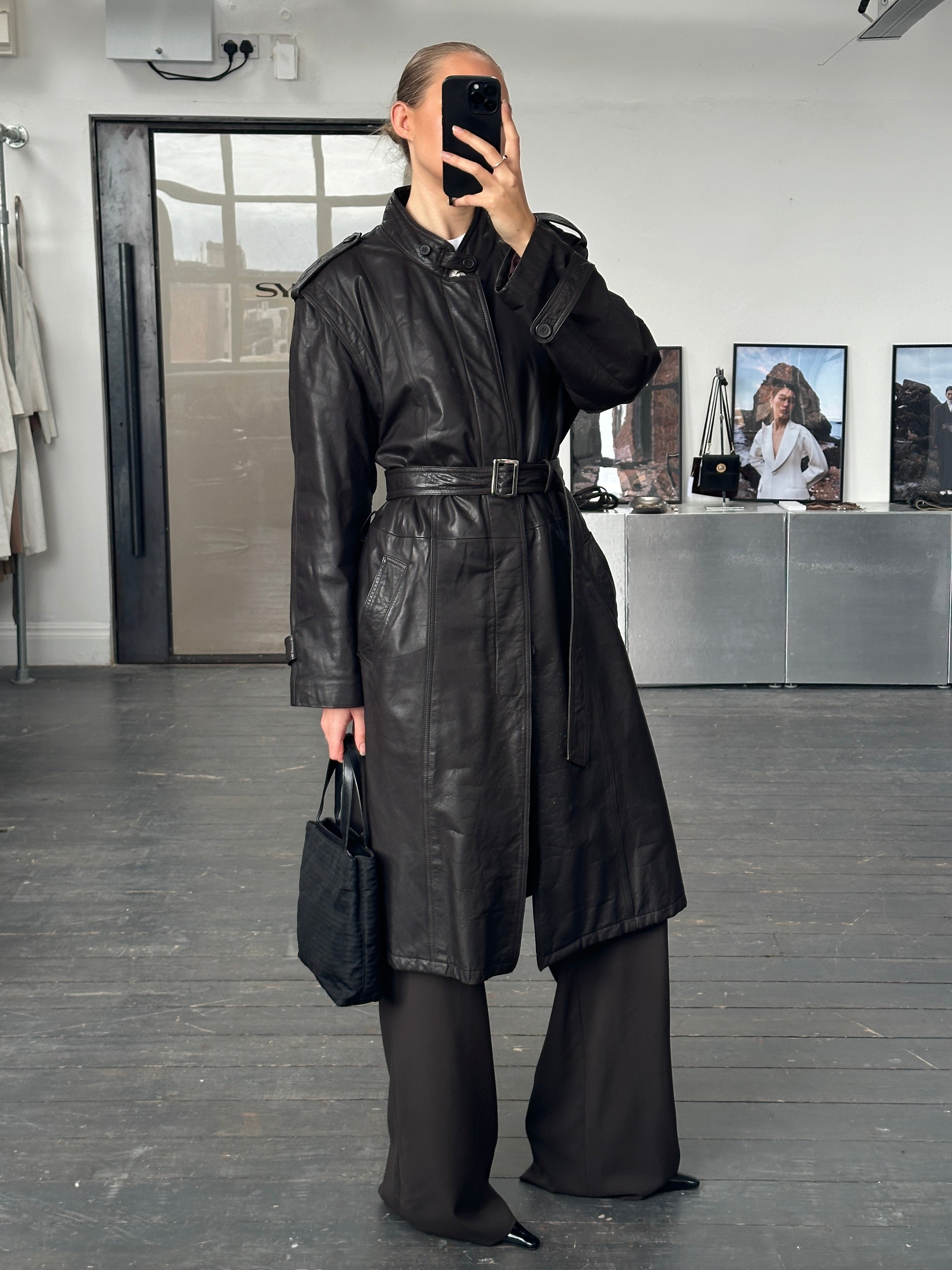 Vintage Italian 1990s leather trench coat with belt, oversized L/XL jacket featuring classic design and weather-resistant material.