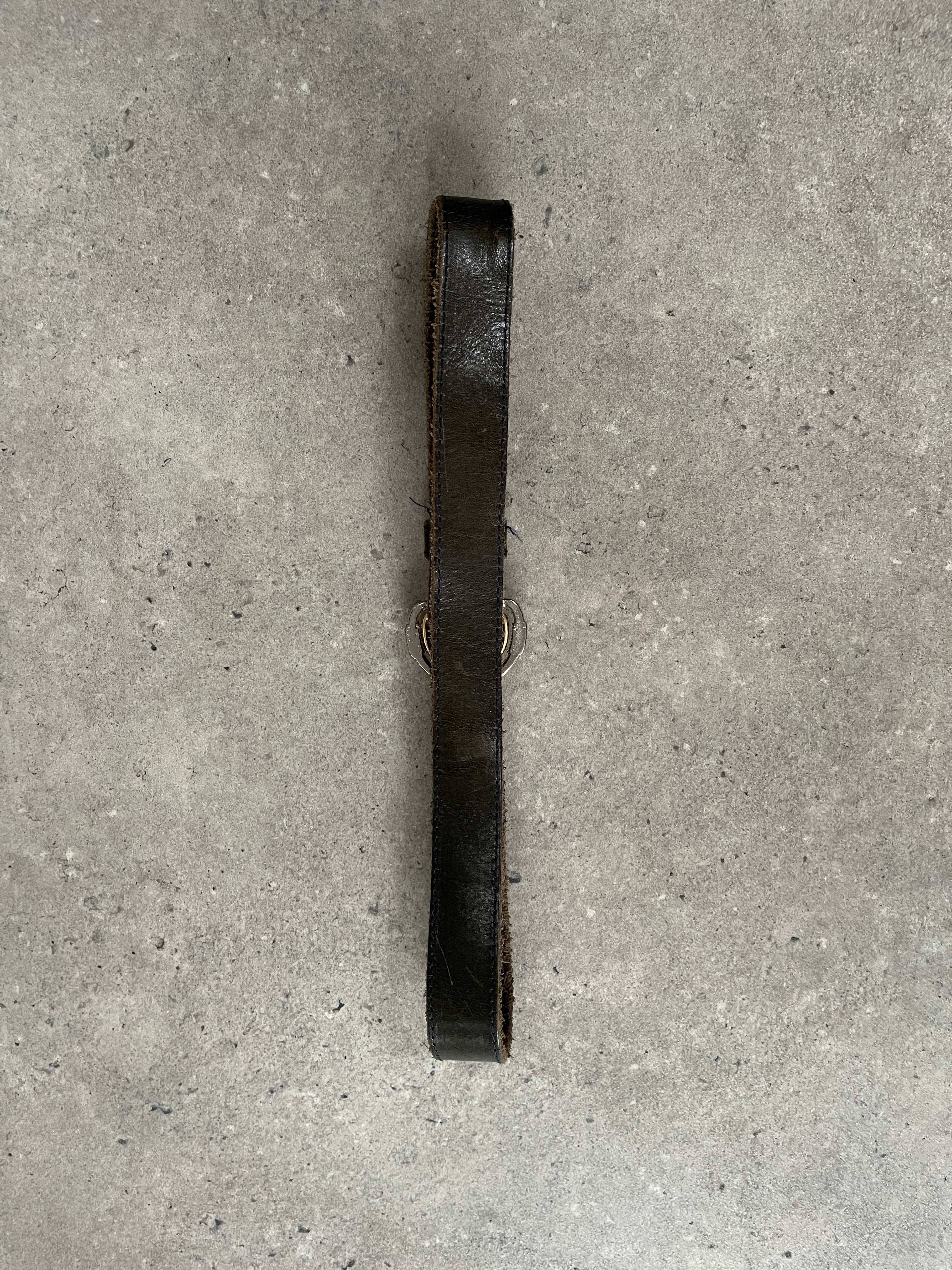 Vintage 1990s double buckle leather belt showing distressed brown leather and metal buckles, vintage style accessory for men and women.