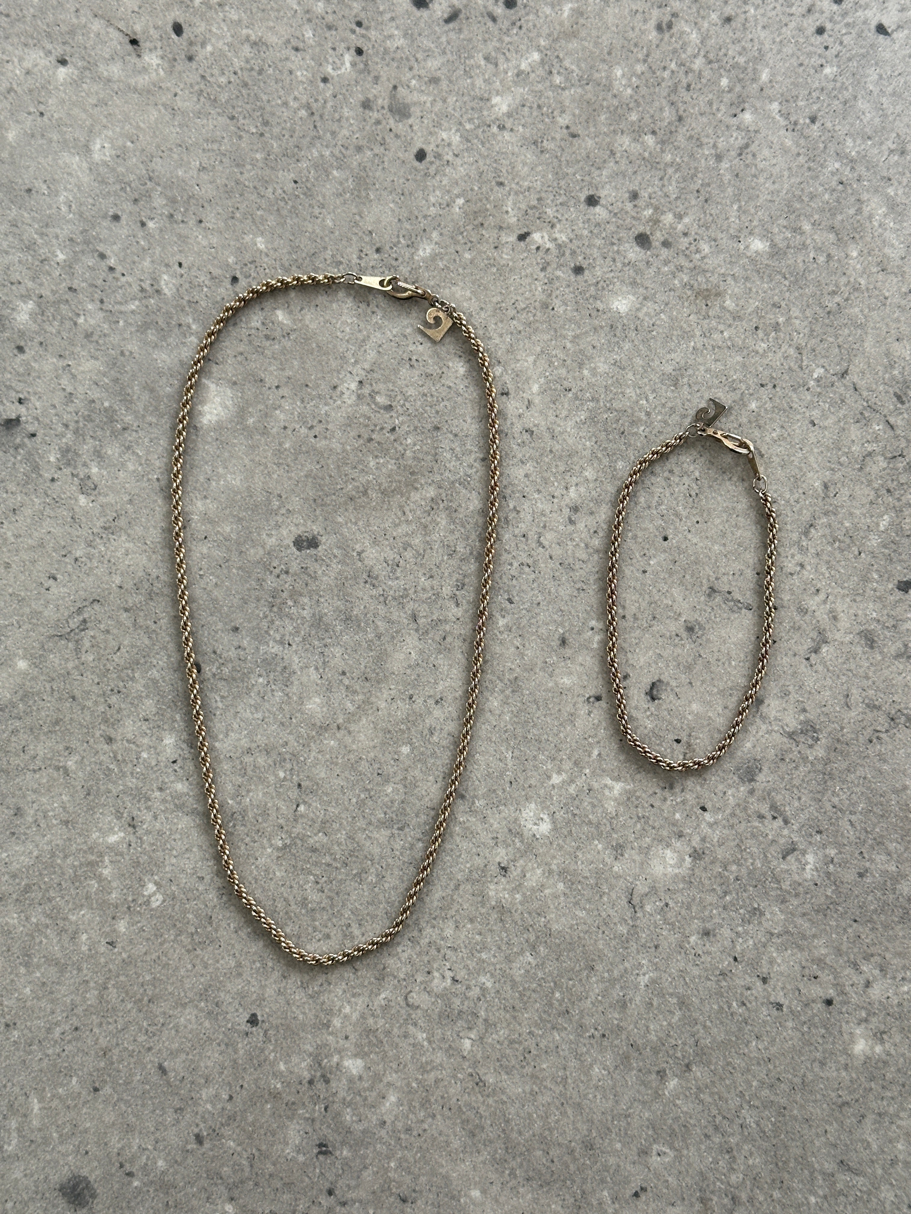 Pierre Cardin gold plated necklace and bracelet chain set with sleek, interconnected links displayed on a neutral background.