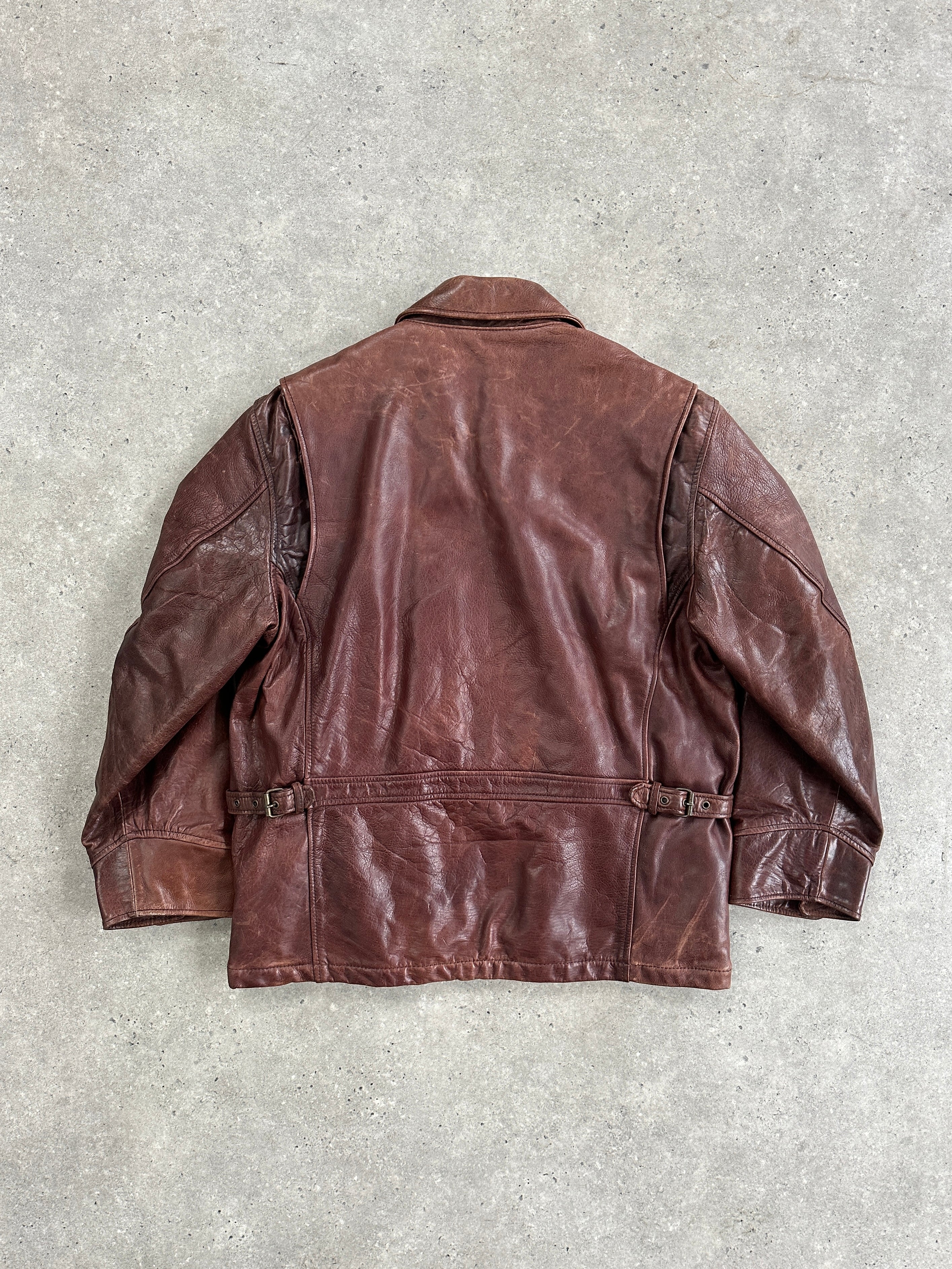 Vintage heavyweight leather jacket in XL size, aged finish with rugged texture, featuring classic collar and front zipper closure.