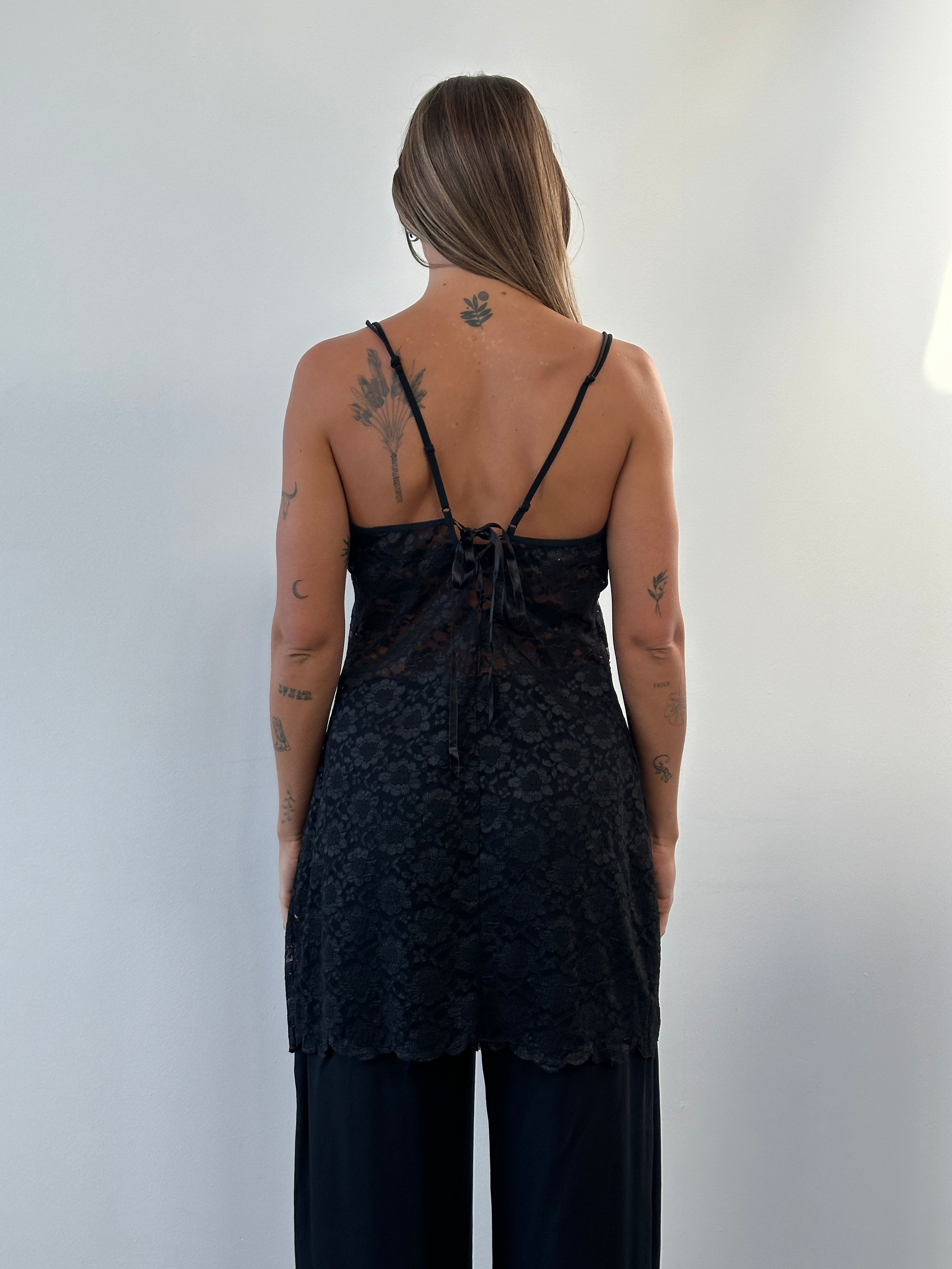 Vintage 1990s sheer lace mini slip dress in beige, with delicate floral patterns and a fitted silhouette.