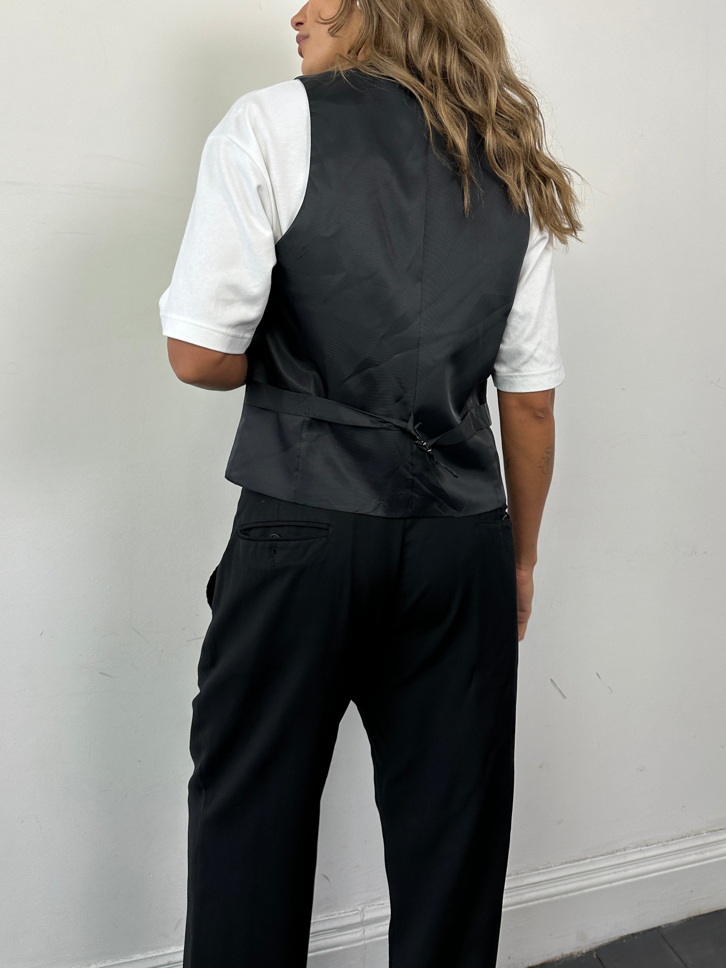 Vintage pure wool tailored waistcoat in size small, featuring classic design and refined craftsmanship.