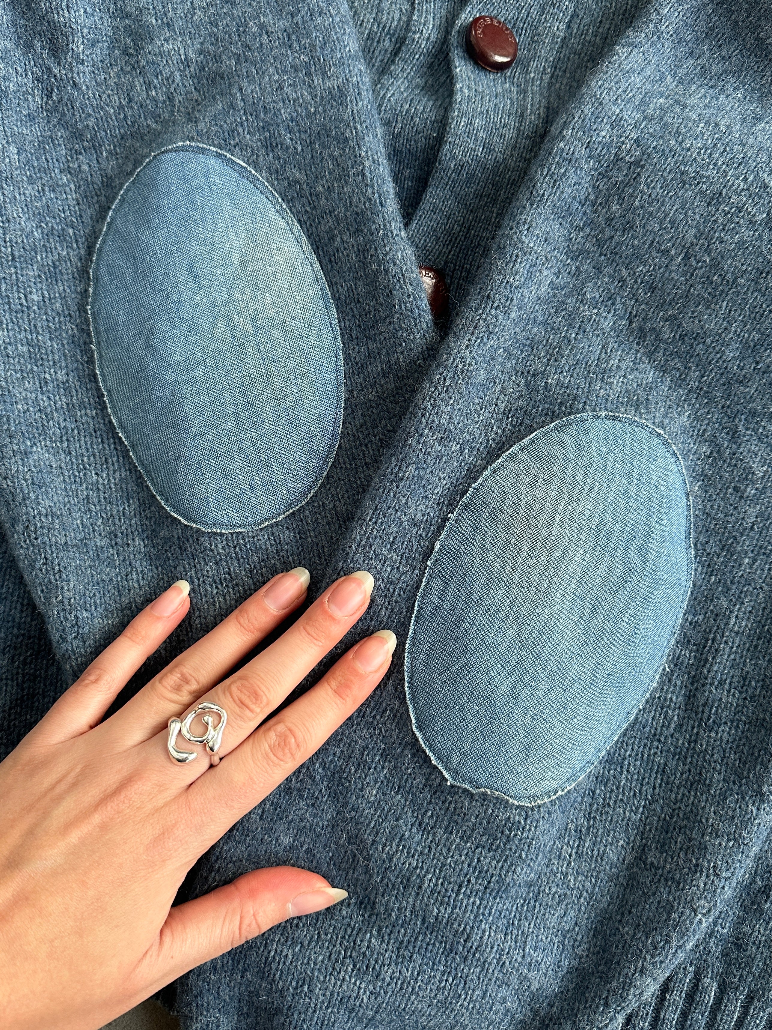 Burberry London wool knitted logo cardigan in size M/L, featuring classic design and signature logo detail.