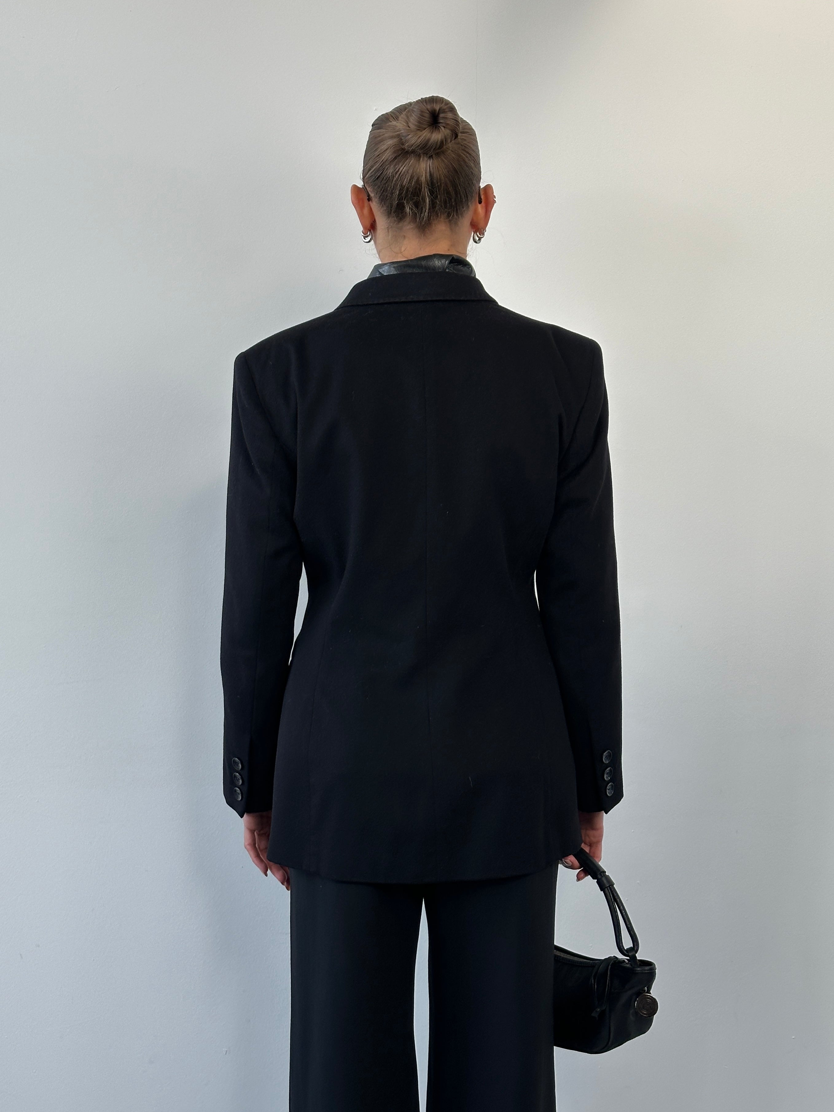 Gianfranco Ferre 1990s wool and cashmere double-breasted blazer in size M, shown hanging on a clothing rack.