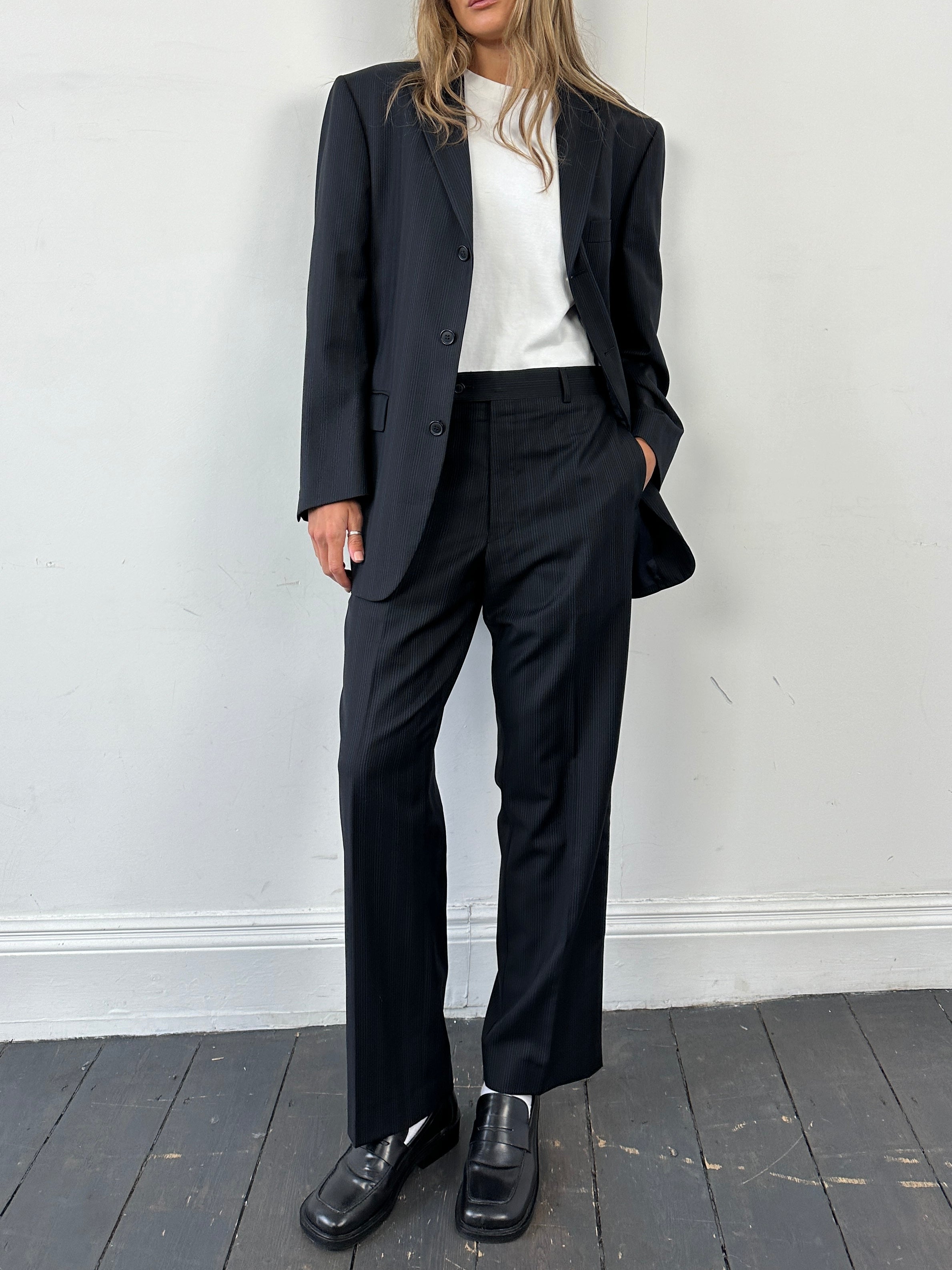 Yves Saint Laurent pinstripe pure wool single-breasted jumpsuit in size 40S/W32, tailored fit with classic lapel collar and front buttons.