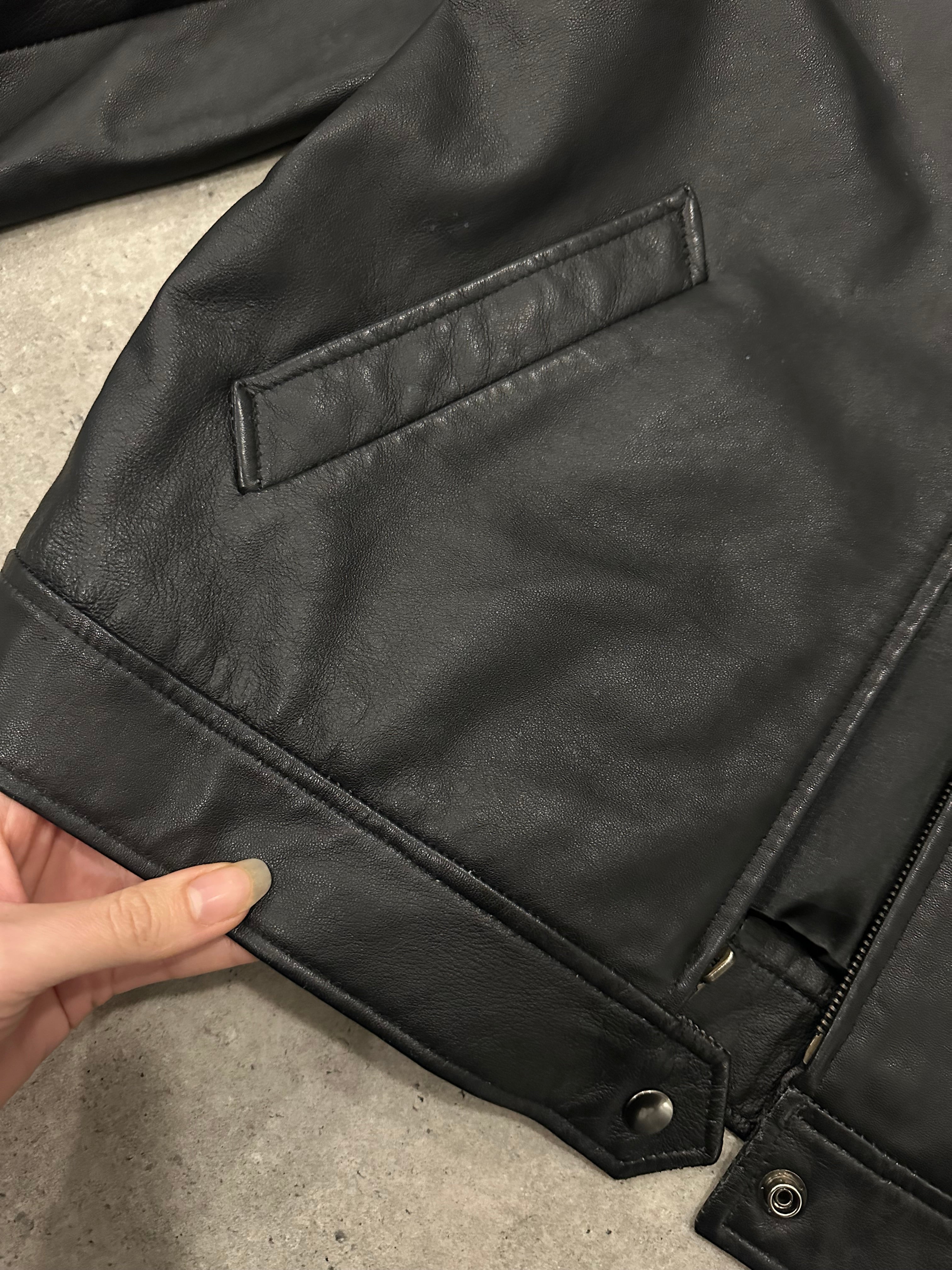 Vintage 1990s leather bomber jacket in size small/medium, classic style with a worn-in leather finish and ribbed collar and cuffs.