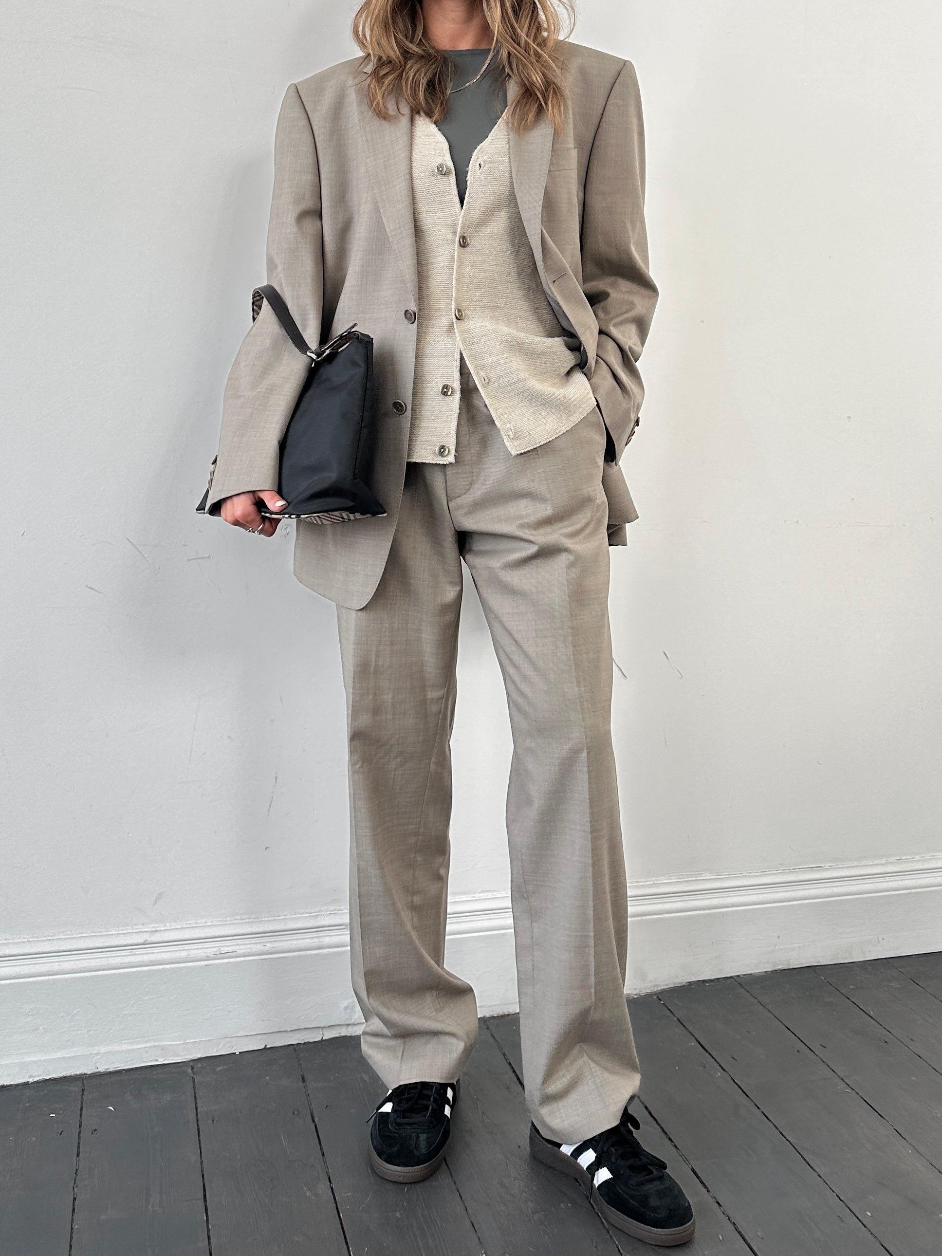 Balmain Homme wool silk single-breasted suit in size 42R/W34, displayed on a hanger, showcasing tailored lapels and fabric details.