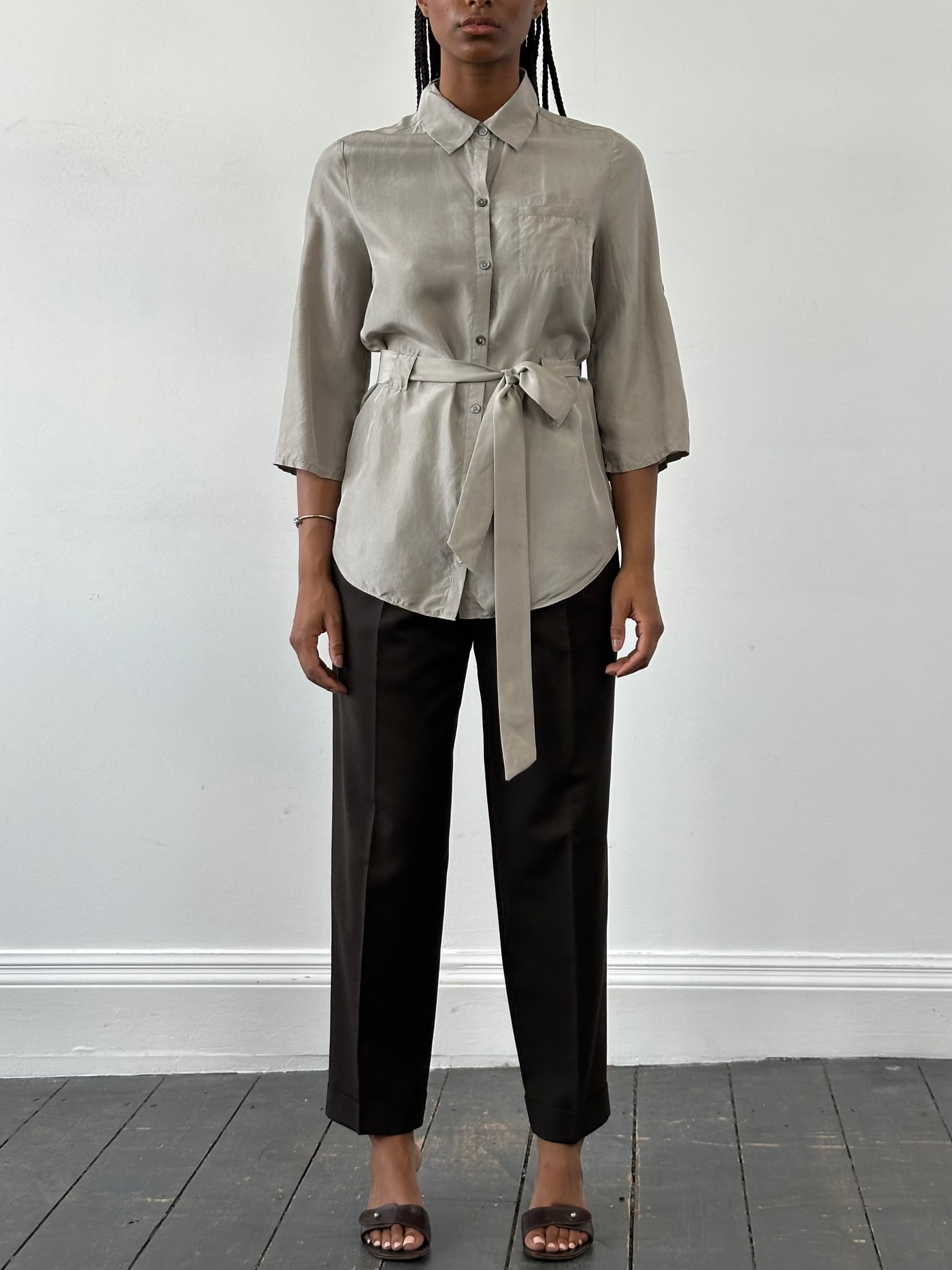 Jaeger pure silk belted shirt in size S, featuring a classic design with a collar, long sleeves, and a waist belt, displayed on a hanger.