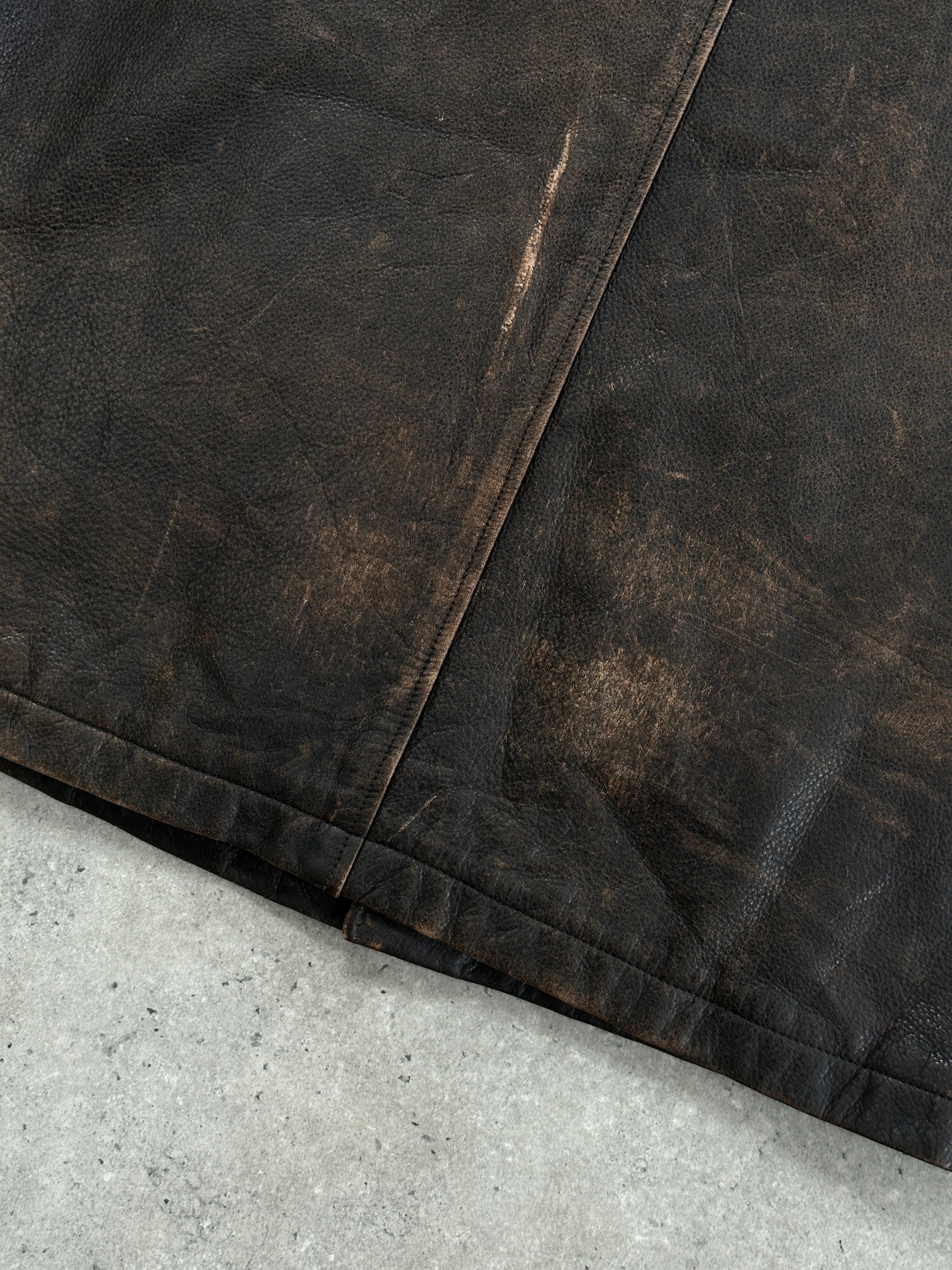Guess distressed leather jacket in XL size, showing the rugged, textured black leather with front zipper and stylish design details.