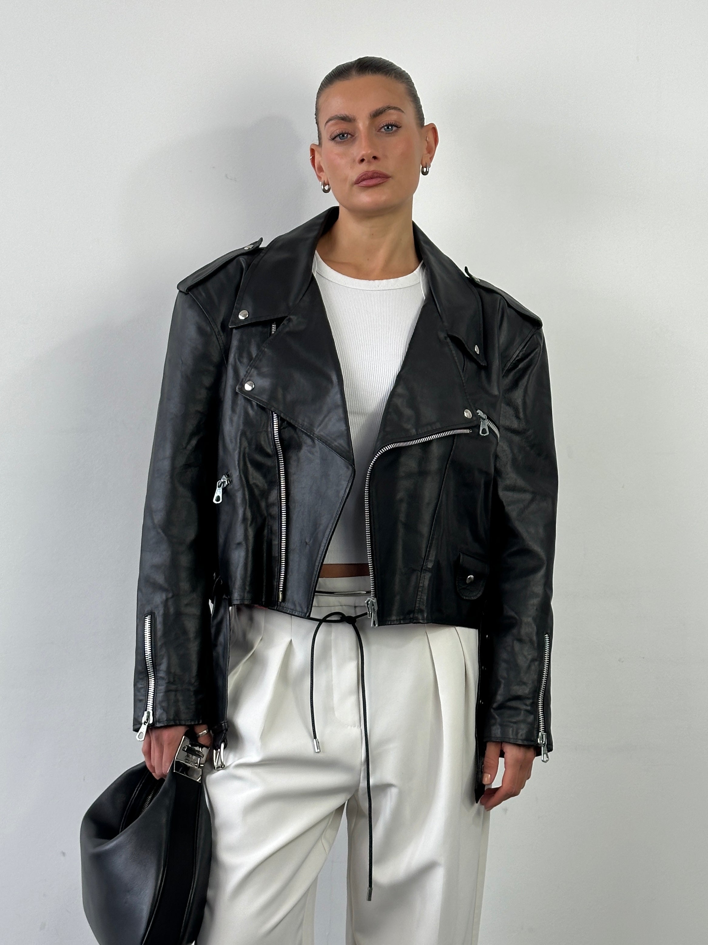 Vintage Italian cropped leather biker jacket, size large, featuring classic biker design with rugged leather and vintage detailing.