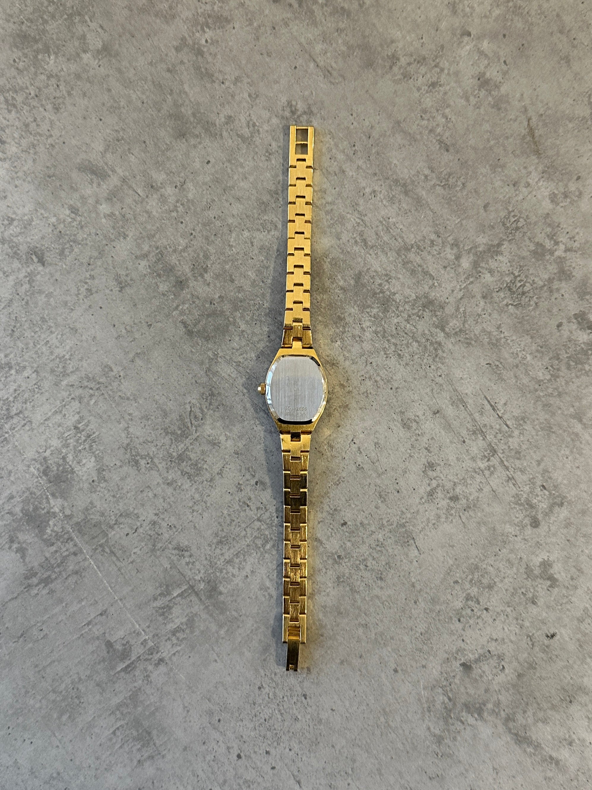 Sekonda 1990s gold-tone quartz watch with classic round dial and sleek band, showcasing vintage style and elegant design.