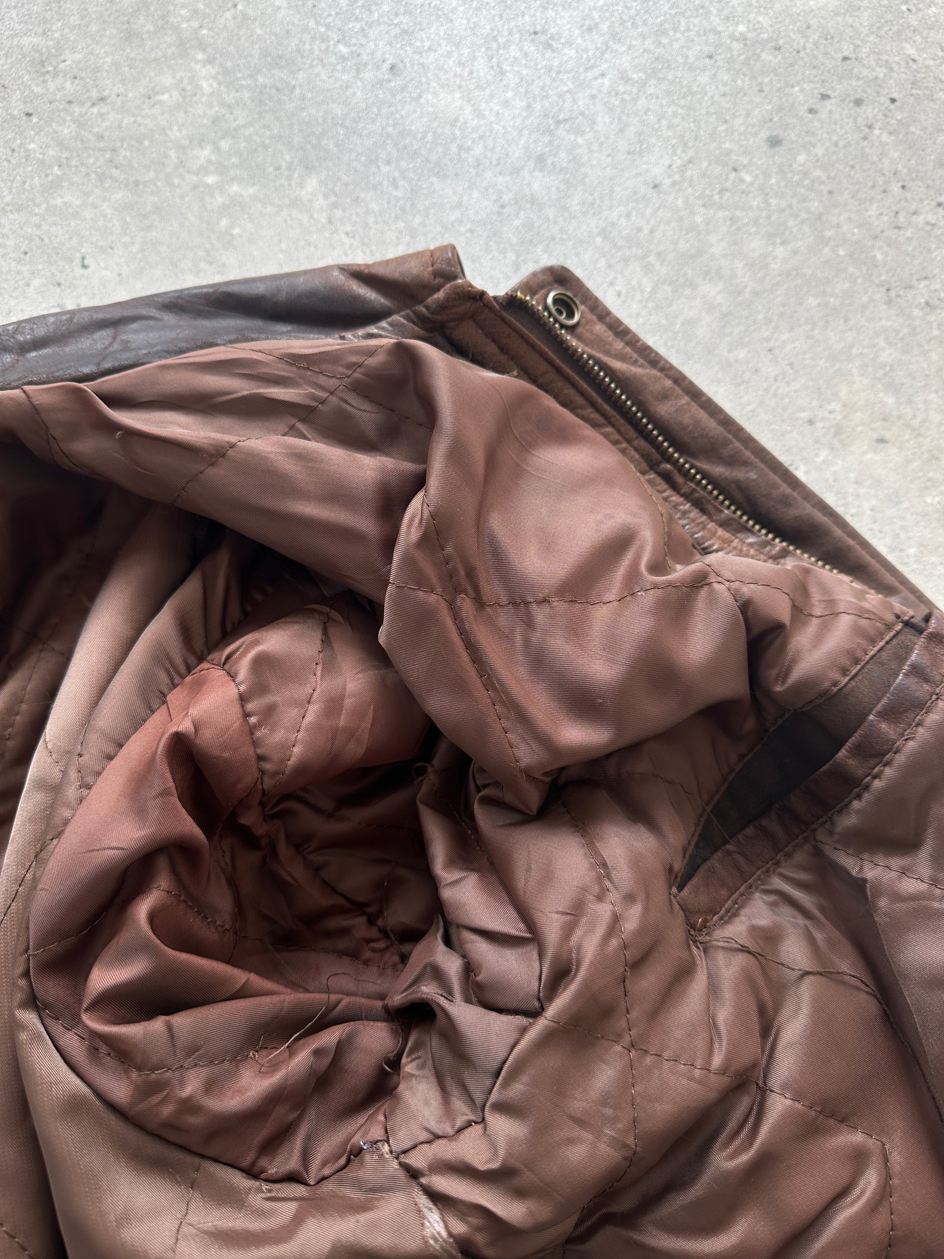 Vintage distressed leather bomber jacket, size large, featuring rugged style and classic design details.