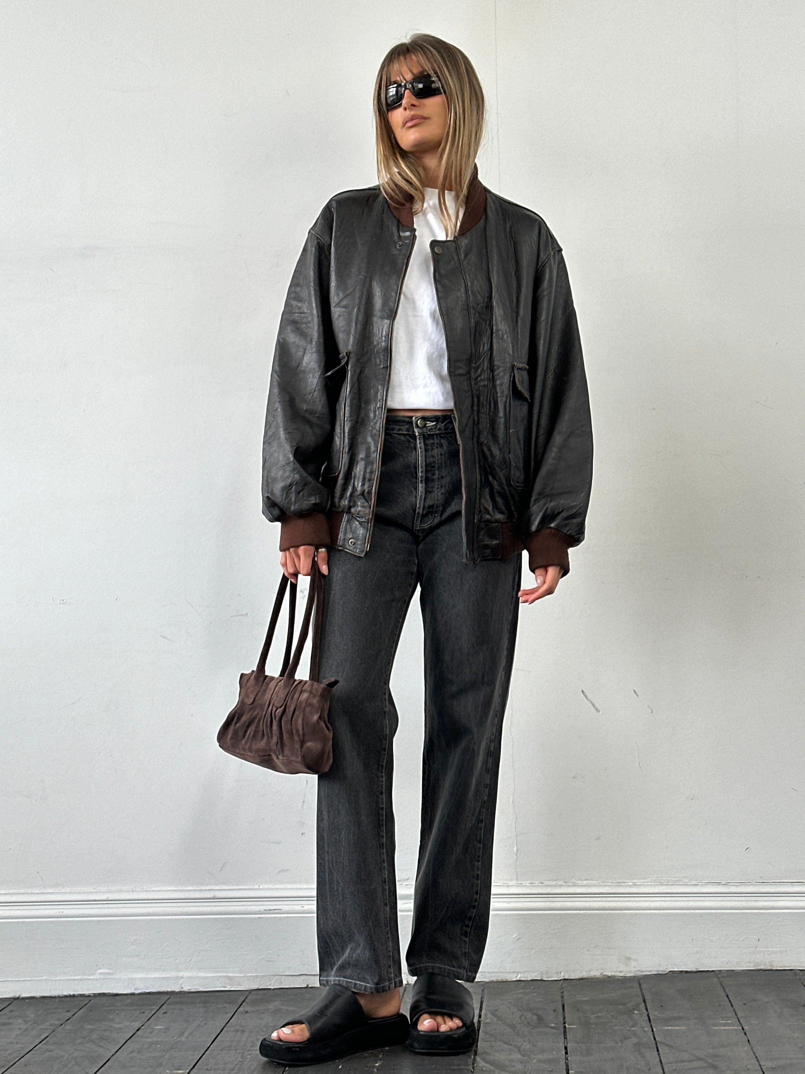 Vintage Italian aged leather bomber jacket in XL, showcasing classic design, distressed leather texture, and vintage style.
