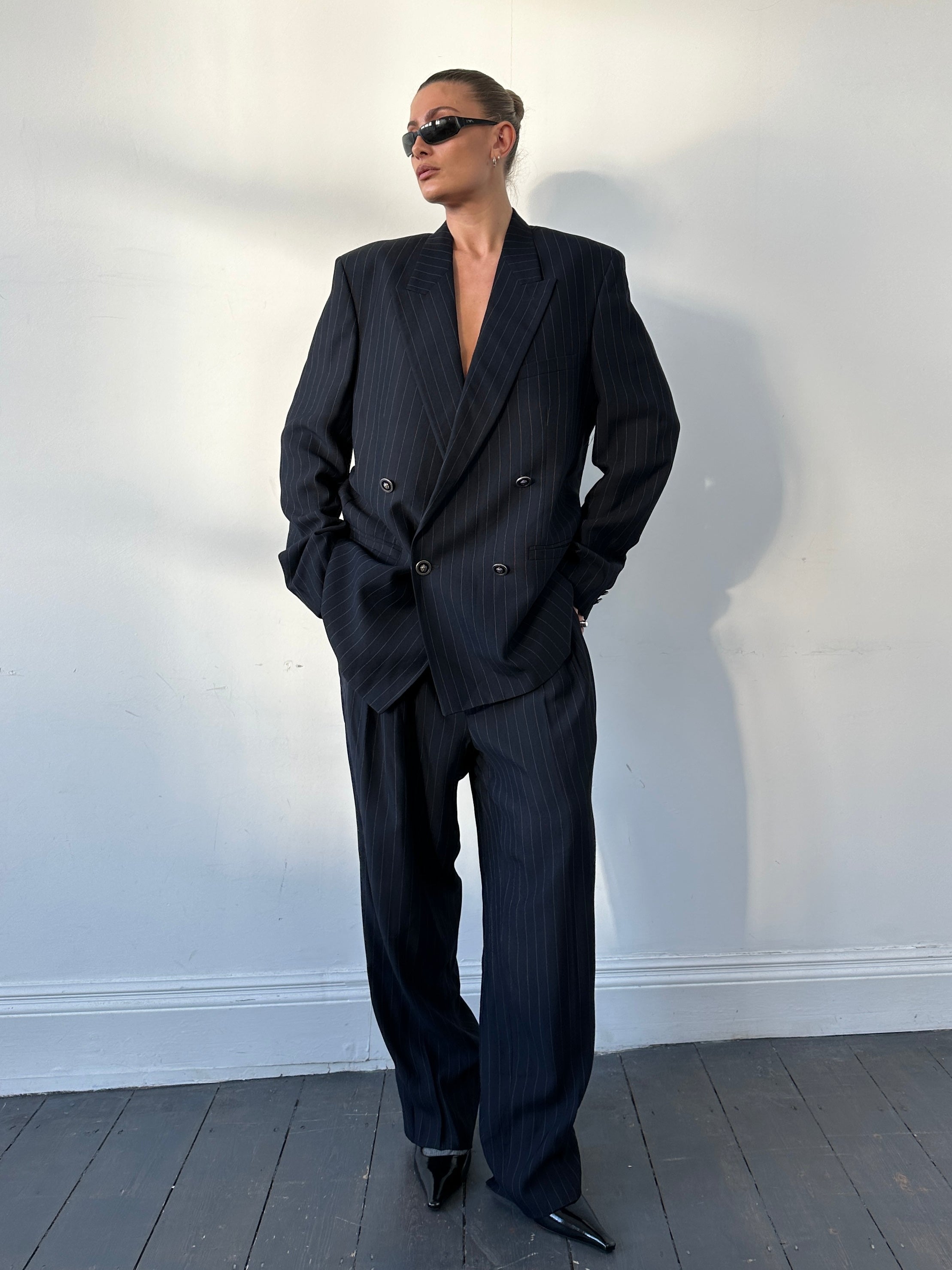 Gianni Versace Versus 1990s pinstripe double-breasted suit, tailored fit, with classic notch lapels and structured shoulders.