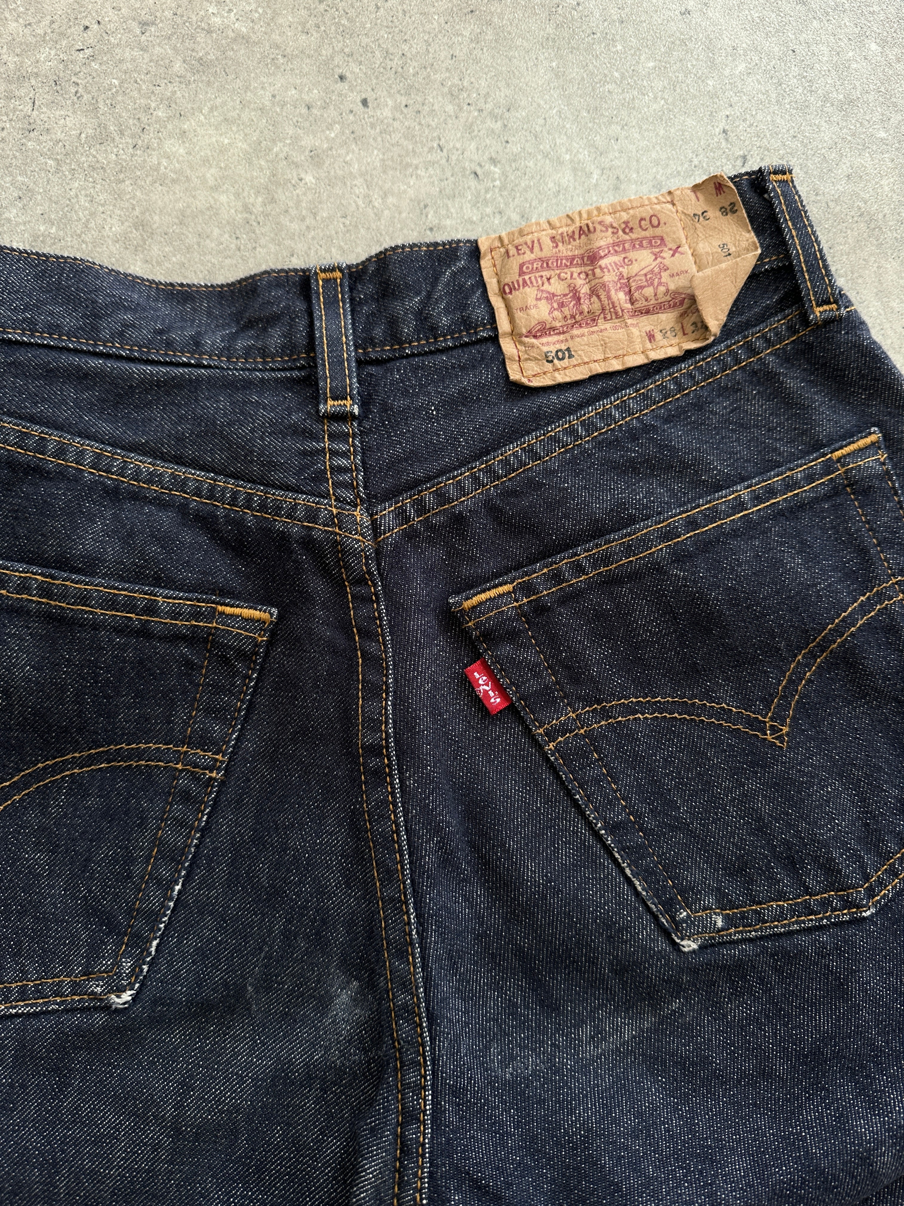 Levi’s 501 straight-leg mid-waisted denim jeans in size W26, showing classic blue denim with button fly and traditional fit.