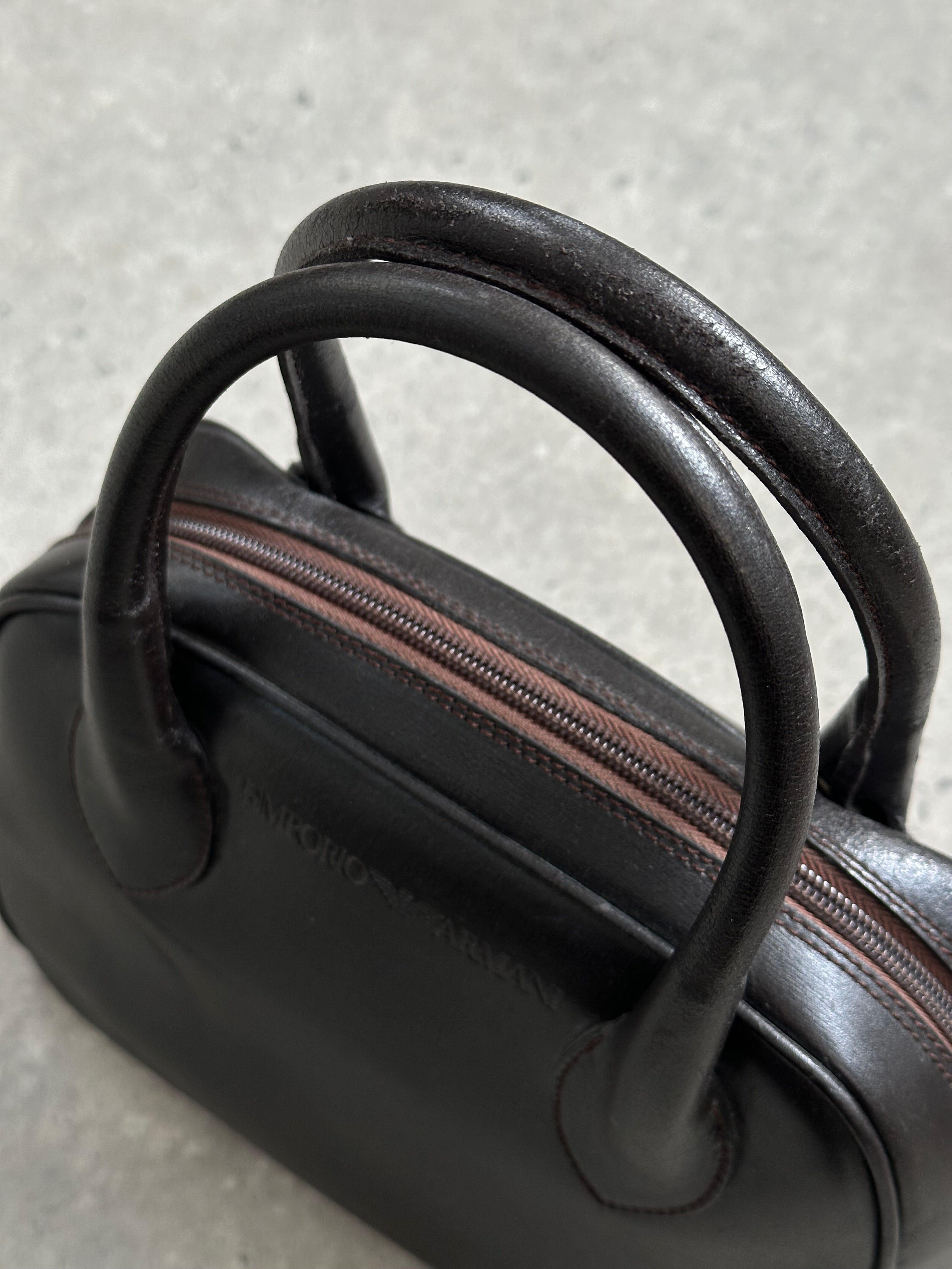 Emporio Armani leather handbag from the 2000s featuring a sleek design, top handle, and signature Armani detailing.