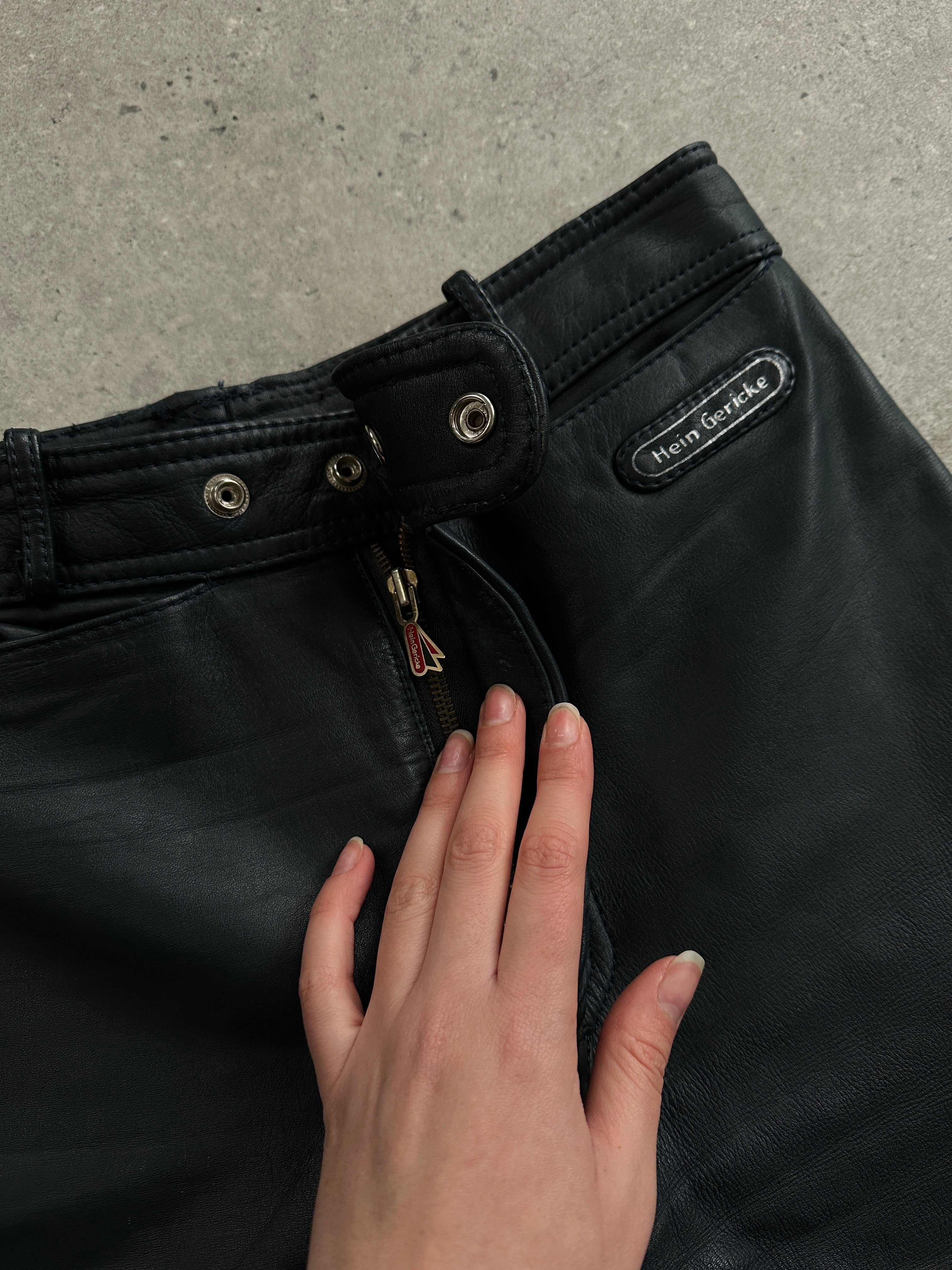Vintage leather straight leg trousers in size W28, showcasing classic style and detailed stitching.