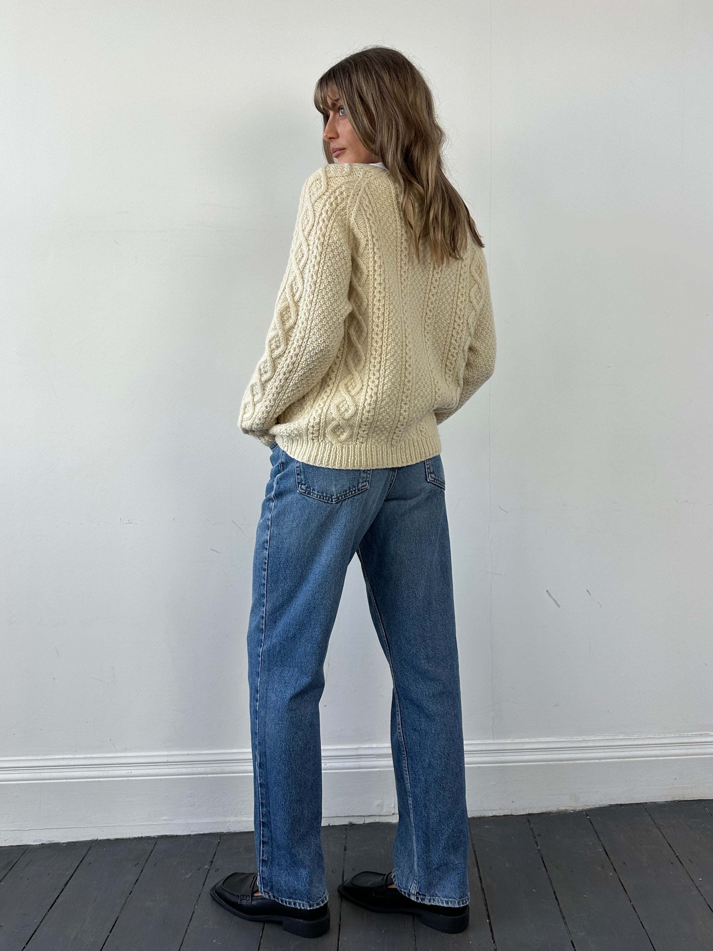 Vintage wool cable knit cardigan in size L, featuring a cozy textured pattern and classic button closure.
