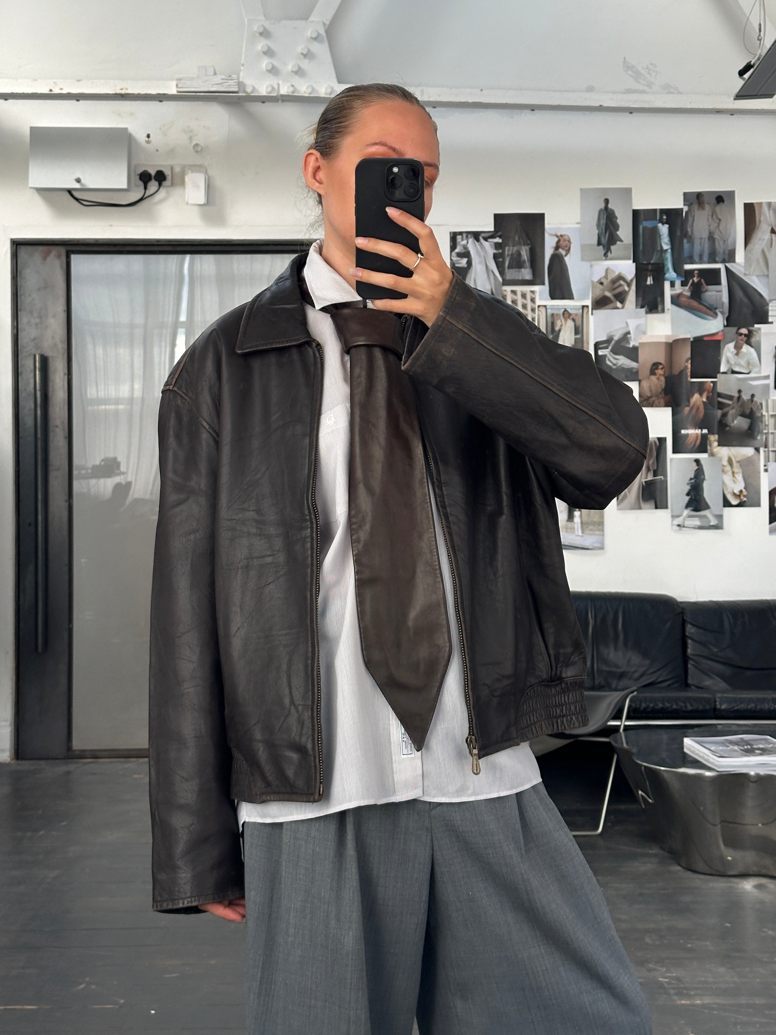 London Fog 1990s distressed leather jacket in size L, featuring rugged texture and classic design, displayed on a hanger.