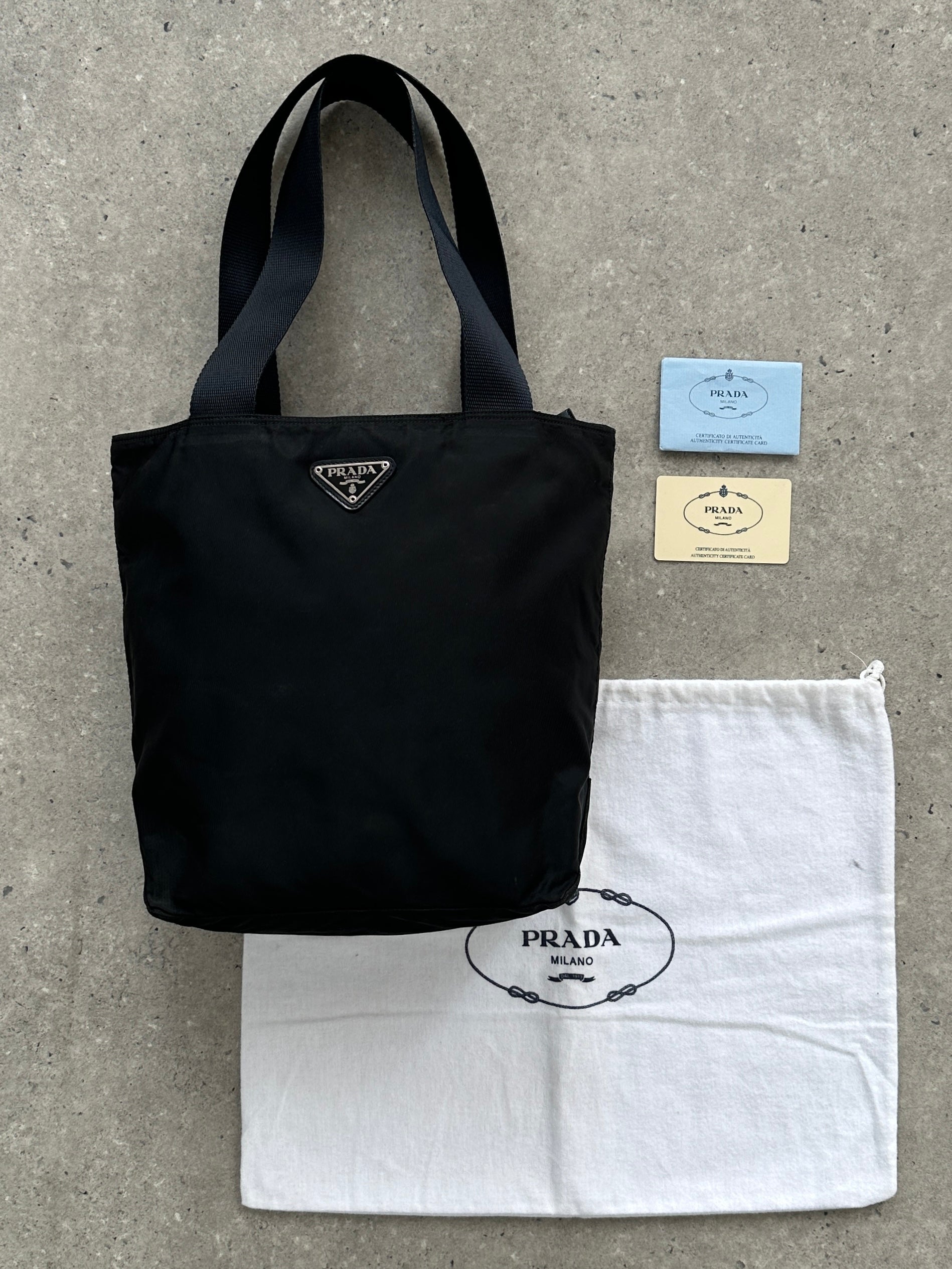 Prada 1997 nylon shoulder bag with sleek design, adjustable strap, and signature Prada logo on the front.