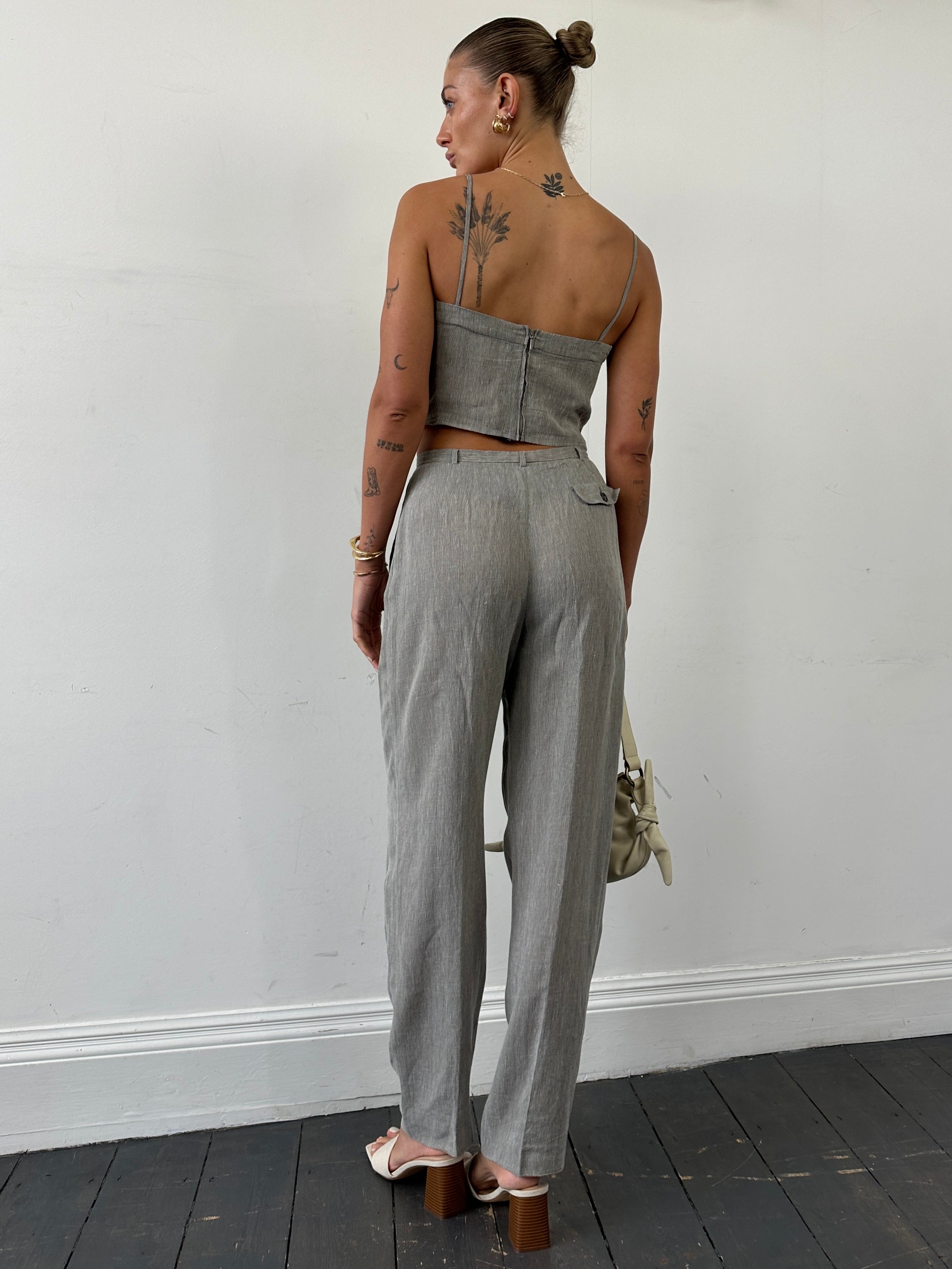 Mani linen two-piece top and trouser co-ord set in soft beige, showing the relaxed fit and lightweight fabric of the trousers.