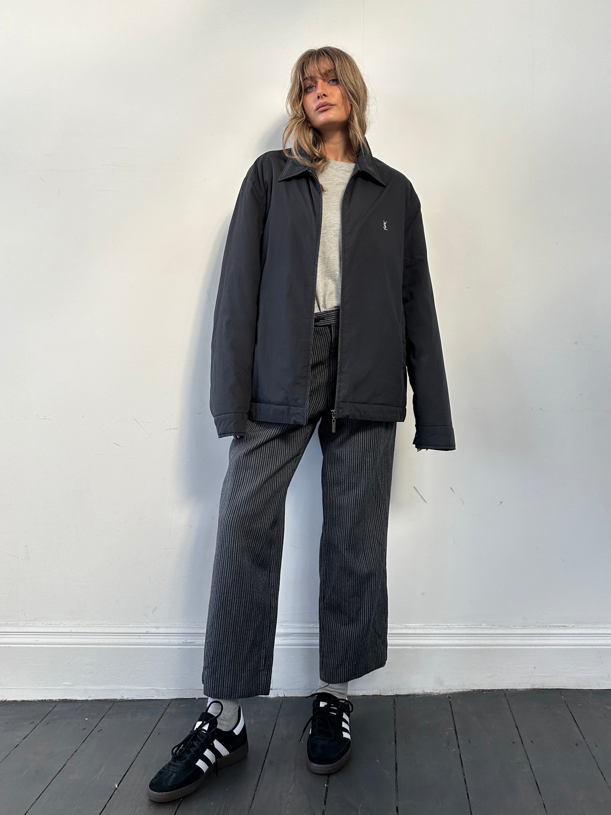 Yves Saint Laurent Harrington jacket in XXL, stylish black jacket with tailored fit and classic design, shown on a hanger.