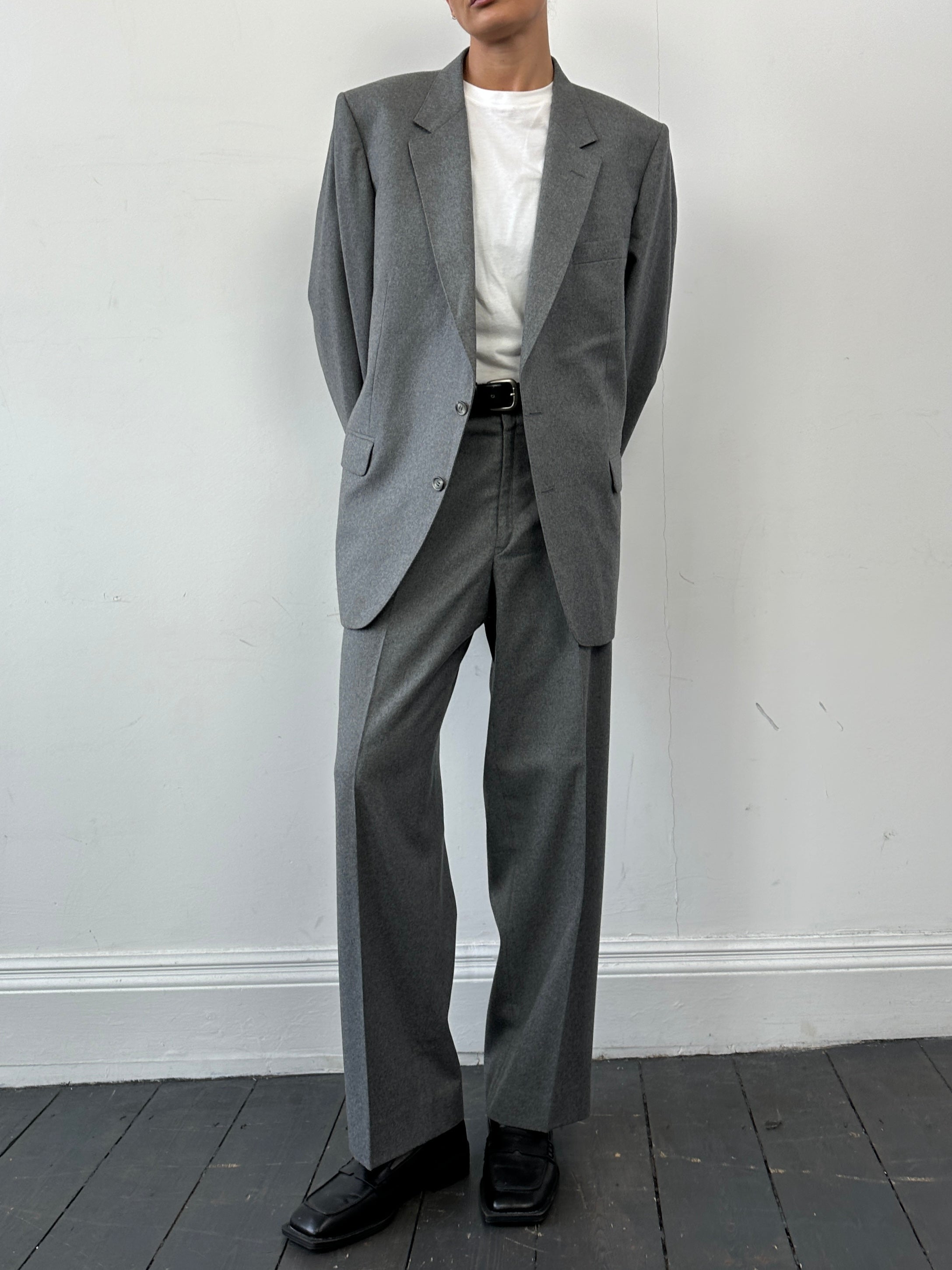 Christian Dior pure wool single-breasted jumpsuit in size 44R/W32, tailored fit with classic lapel and button closure.