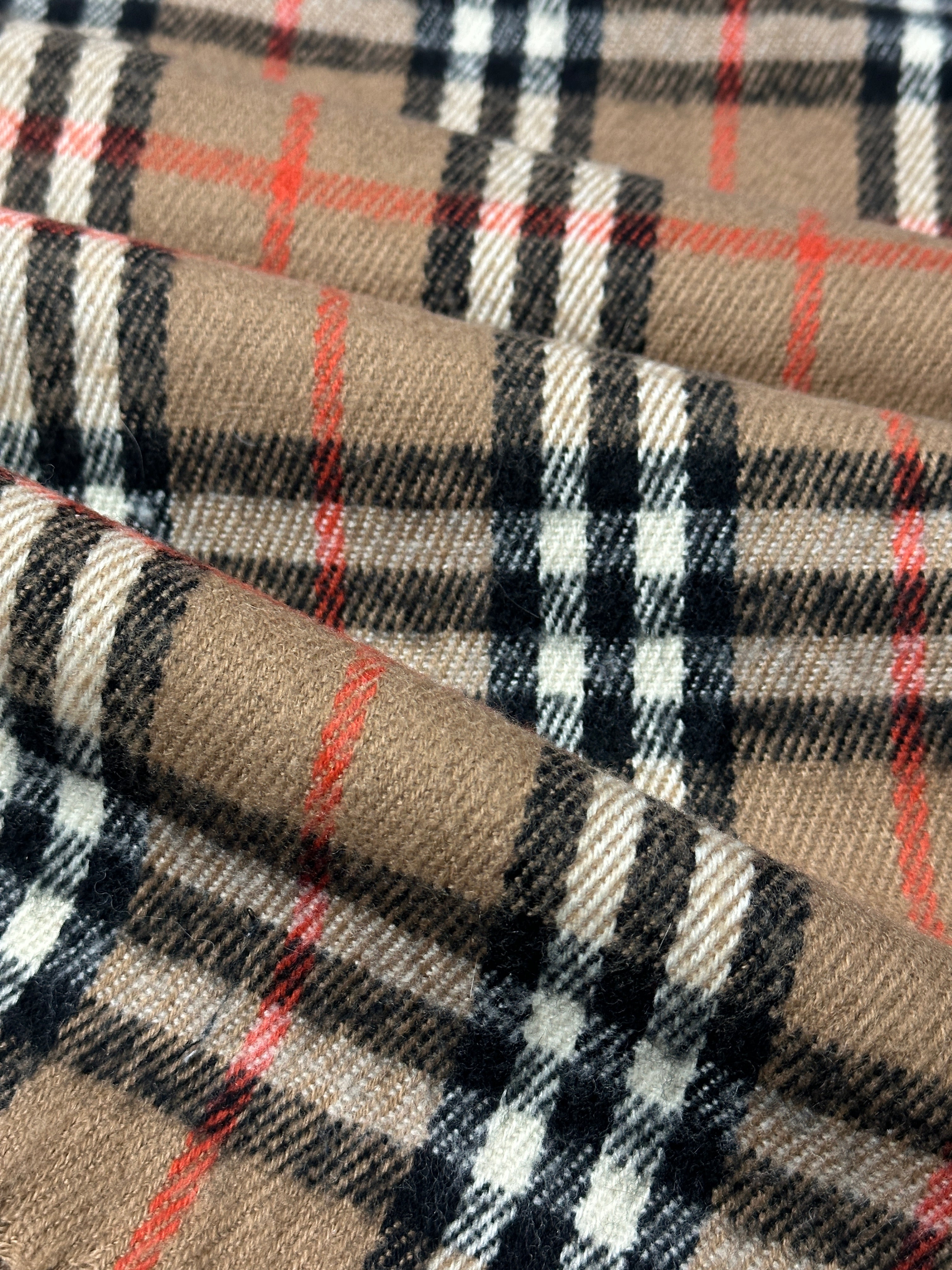 Vintage Nova Check scarf featuring a classic plaid pattern in soft, woven fabric, styled with fringe edges.