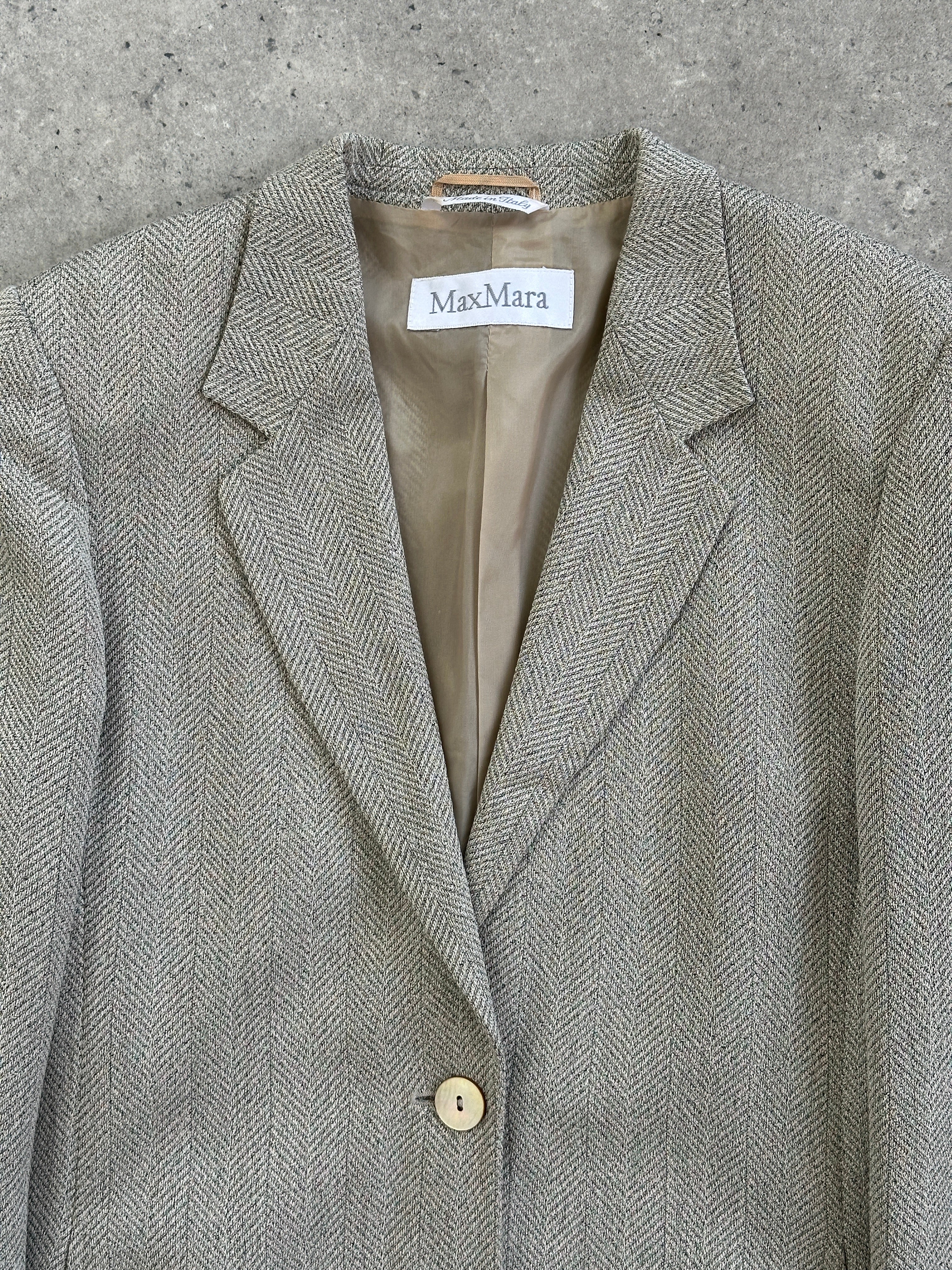 Max Mara relaxed single-button herringbone blazer in neutral tones, tailored fit, displayed on a hanger.